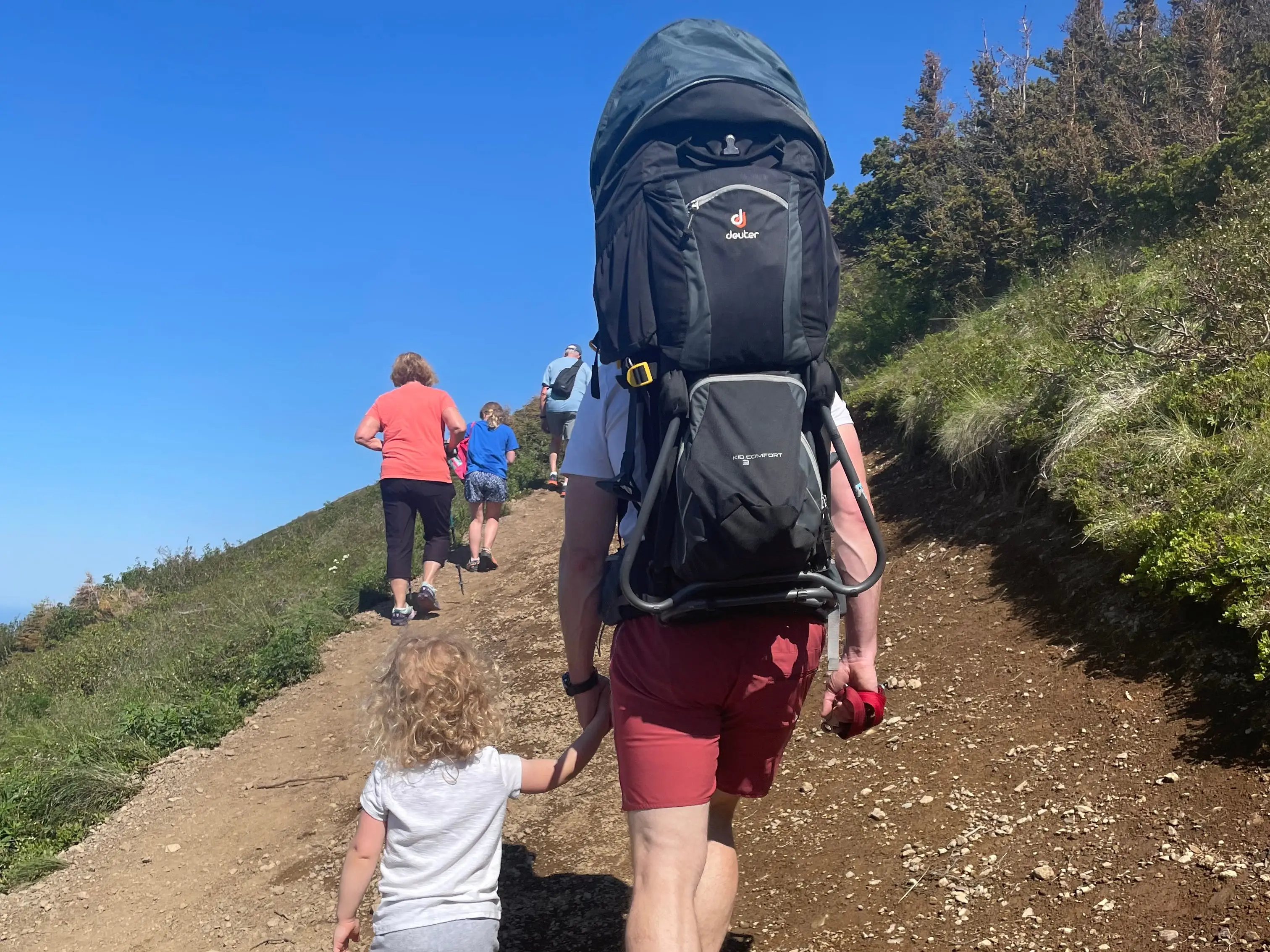 Dr. Jake Kelly hiking with his young kids