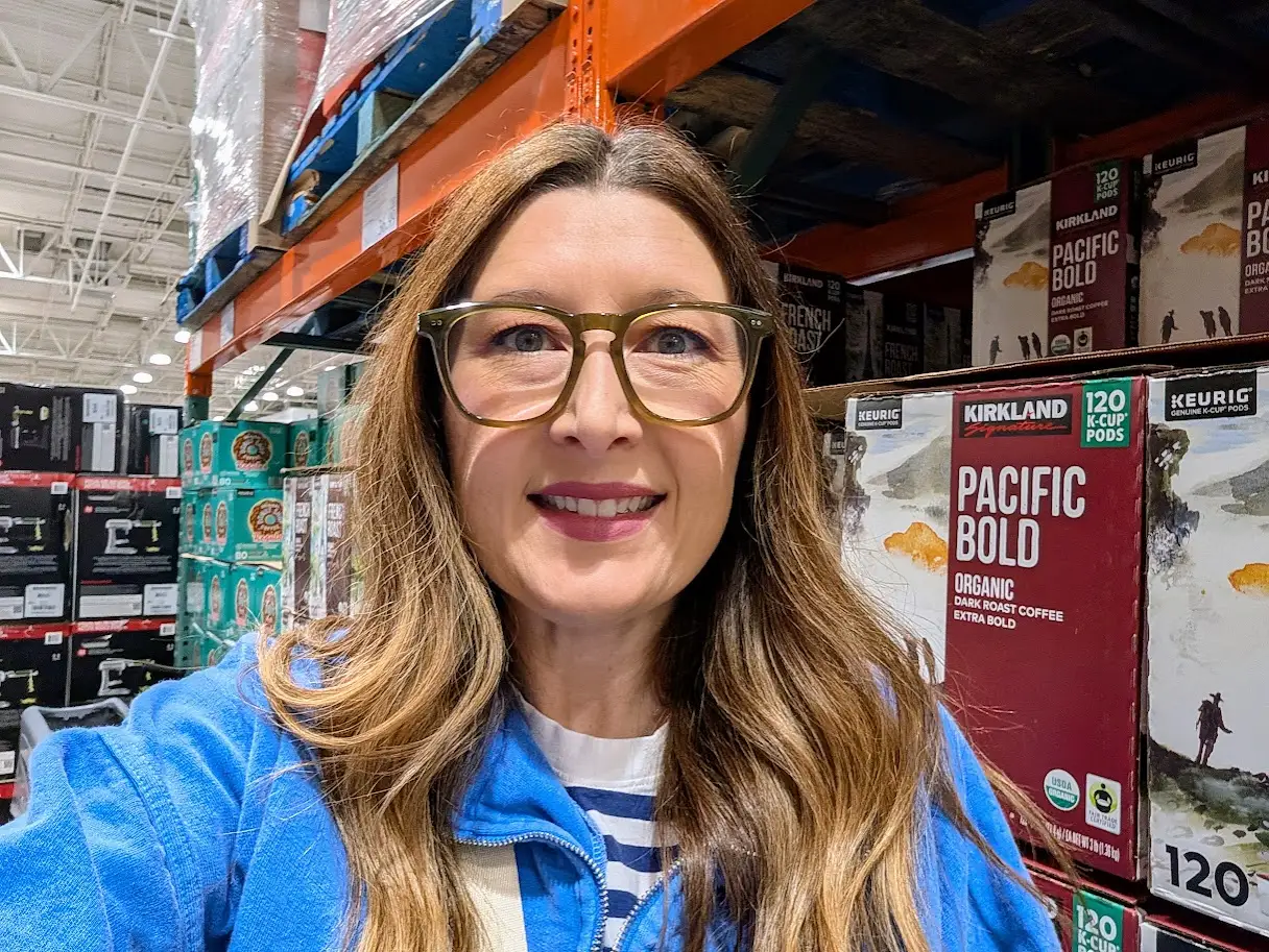 Author Blythe Chadim smiling in selfie taken in Costco aisle