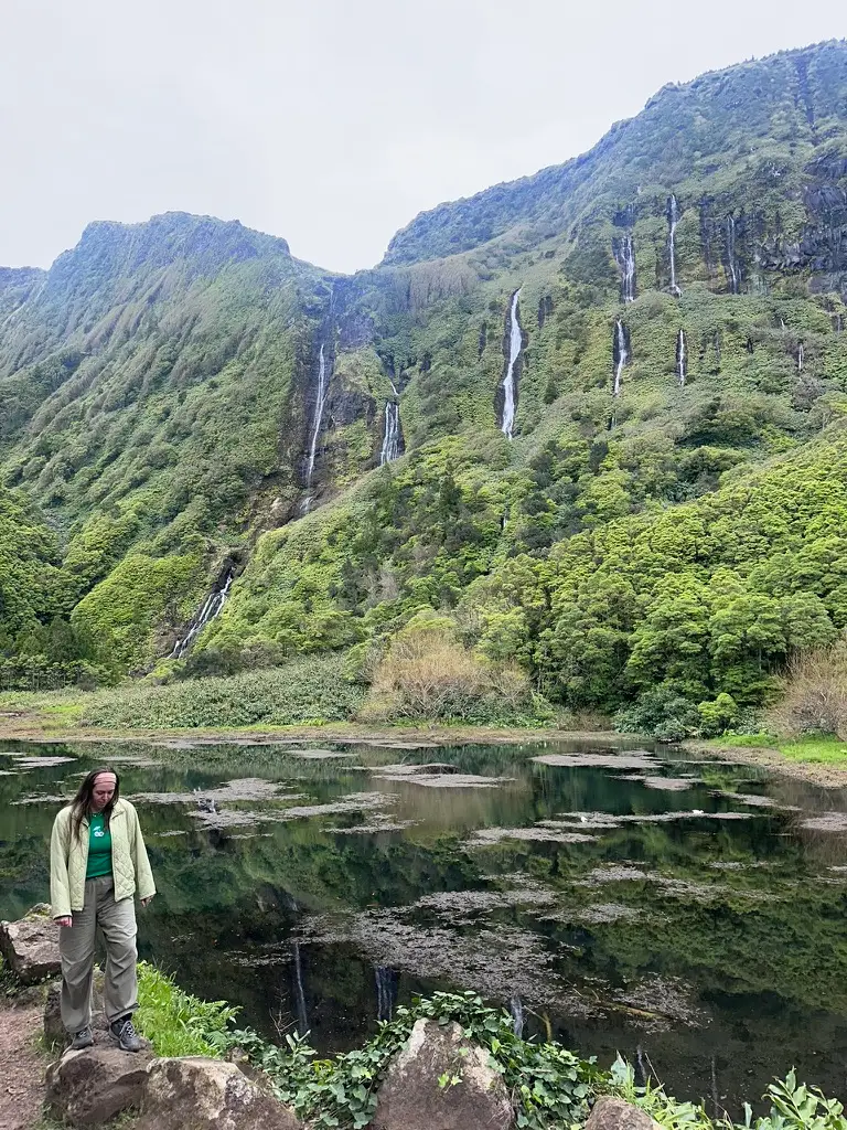 Lily in front of a wall of waterfalls on Flores in Azores
