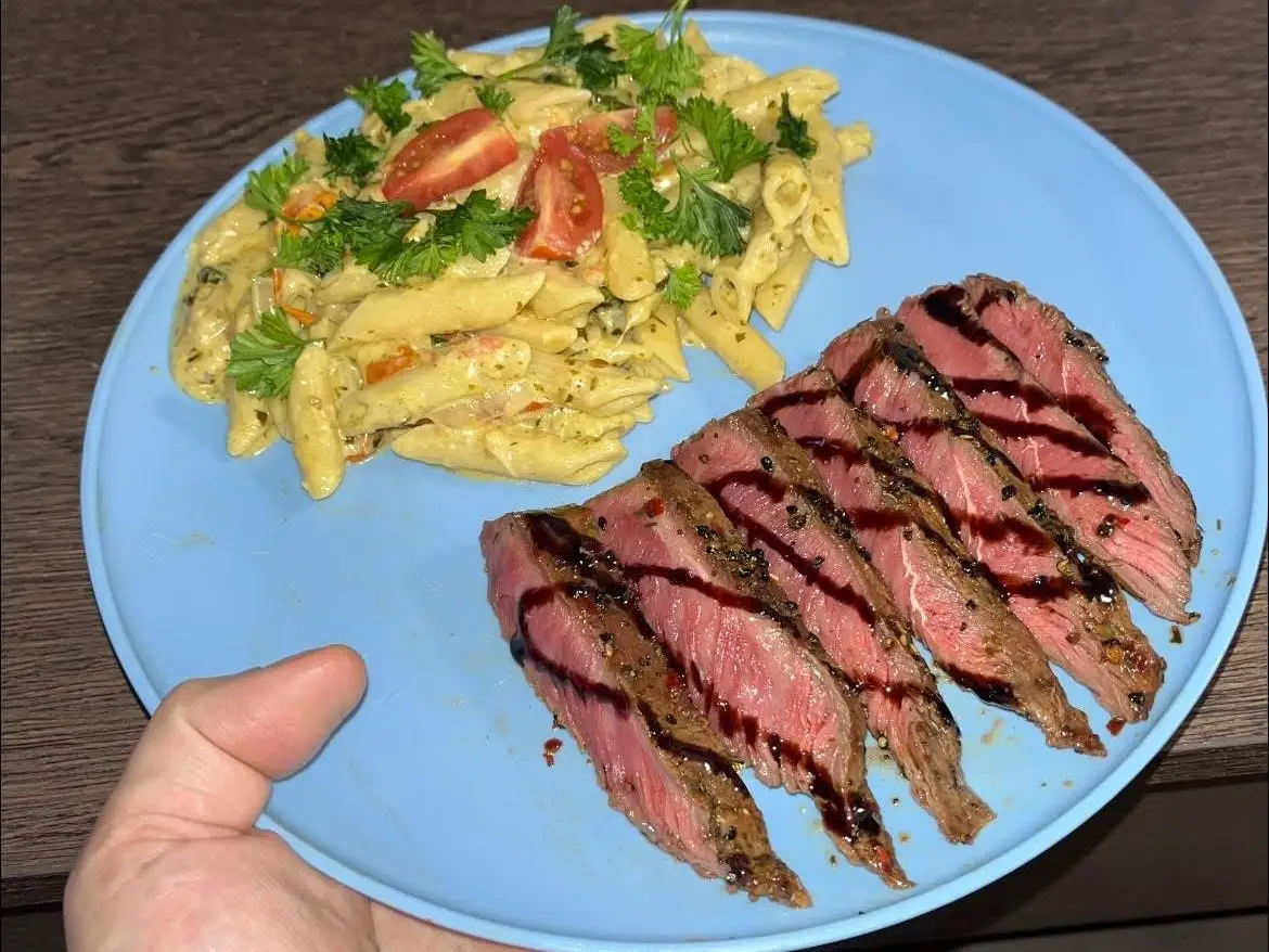 A dish of pasta and steak.