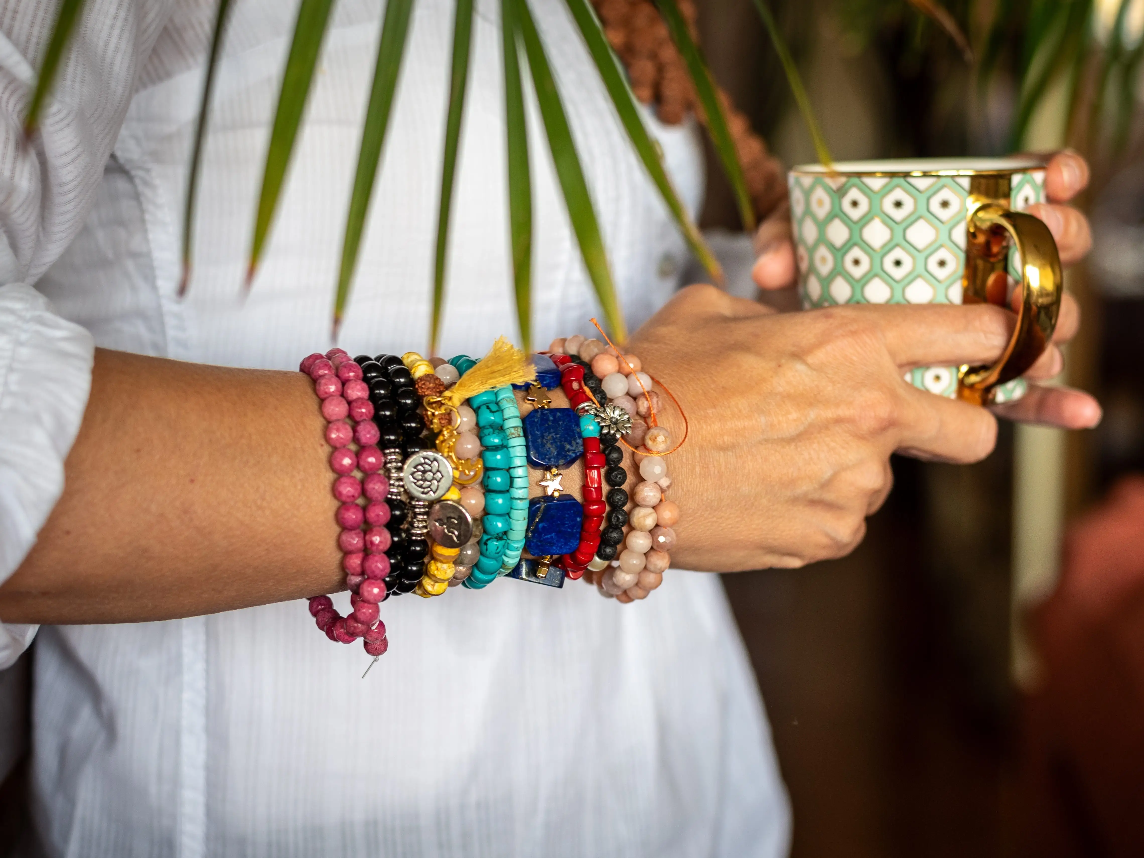 A stack of colorful beaded bracelets worn on someone's arm.
