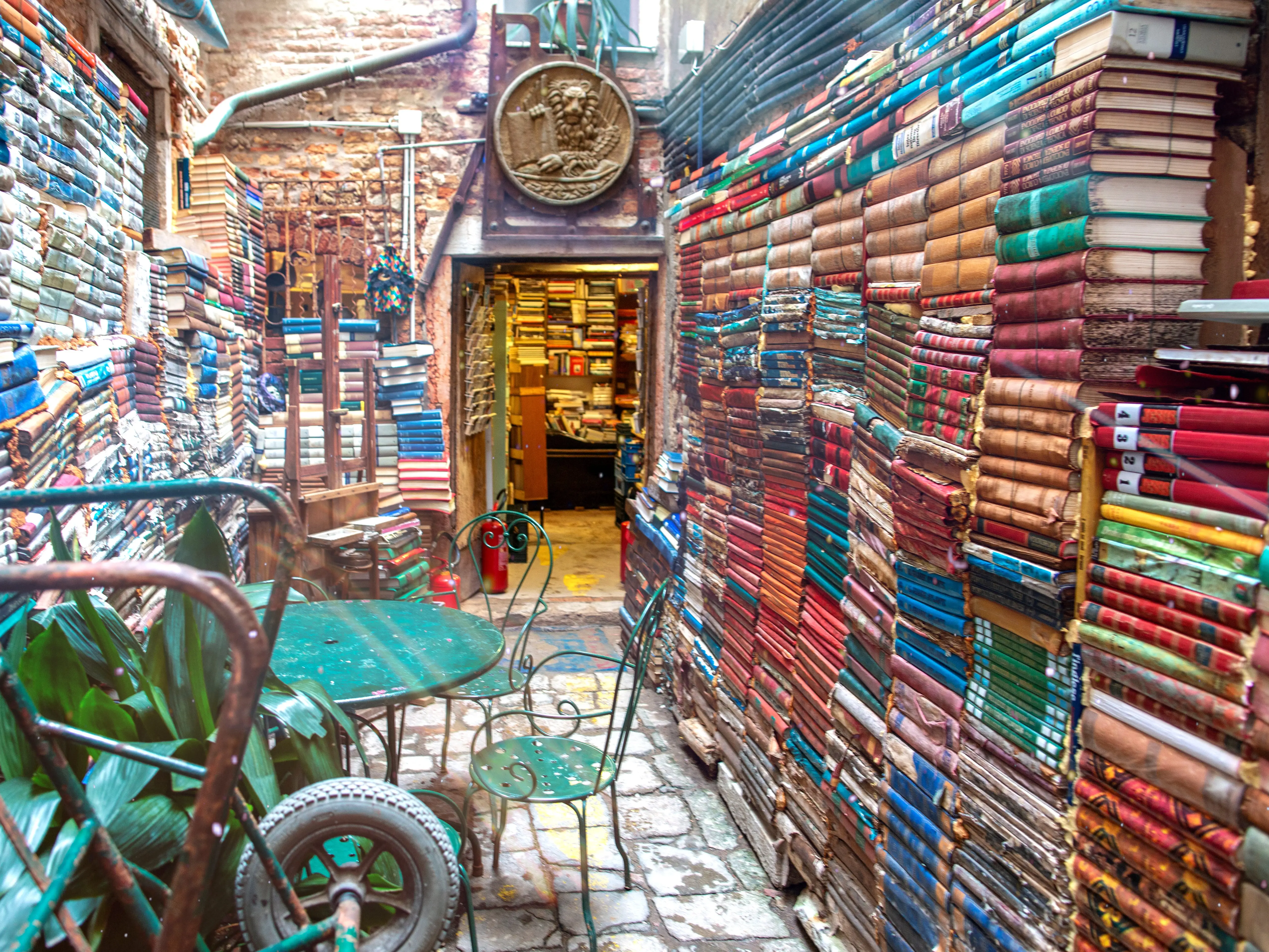 Walls lined with books at Libreria Acqua Alta in Venice, Italy.