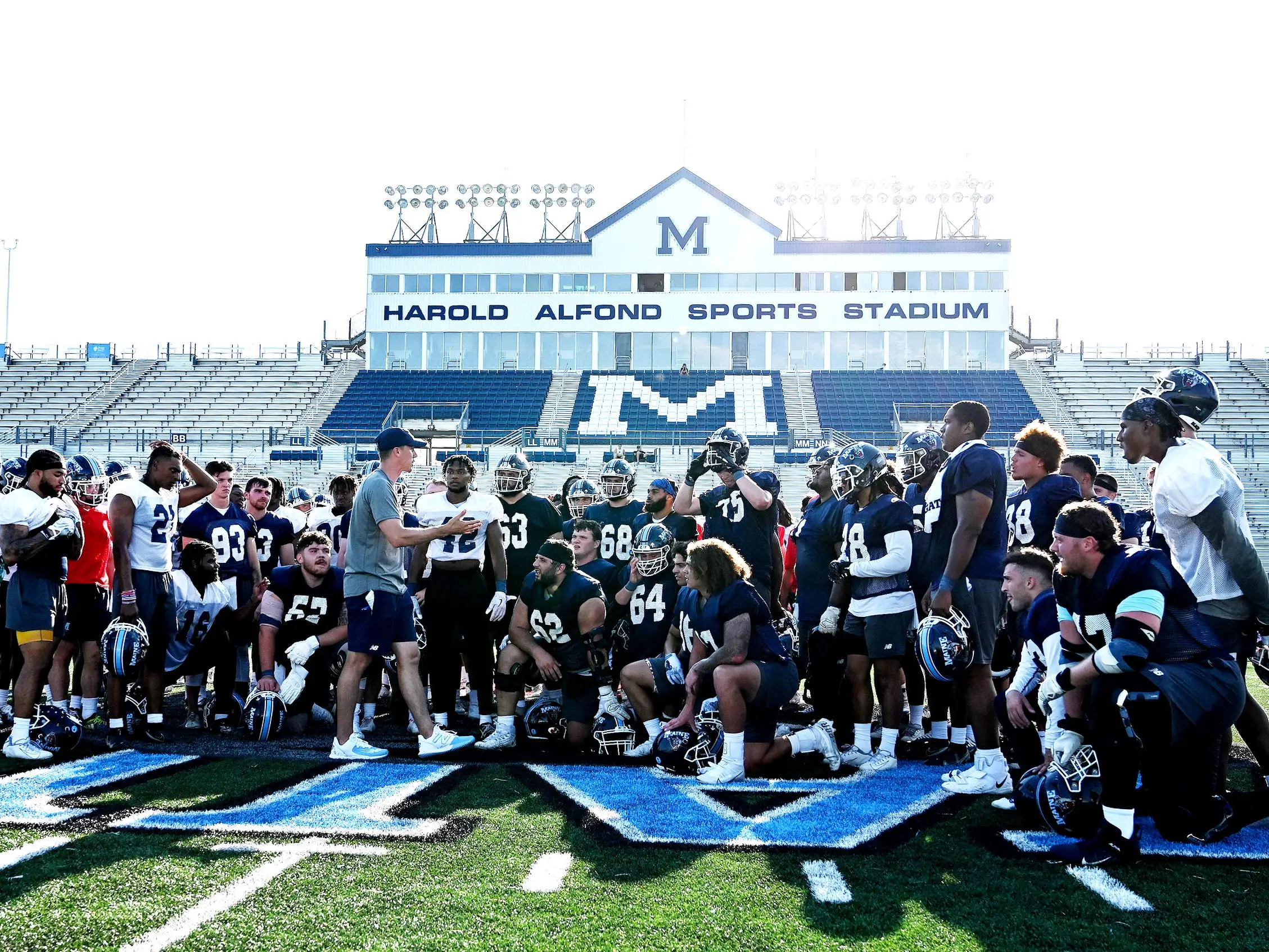 ORONO, ME - August 4: Head Coach Jordan Stevens talks with his team near the end of the teams first practice at the University of Maine Thursday August 4, 2022.