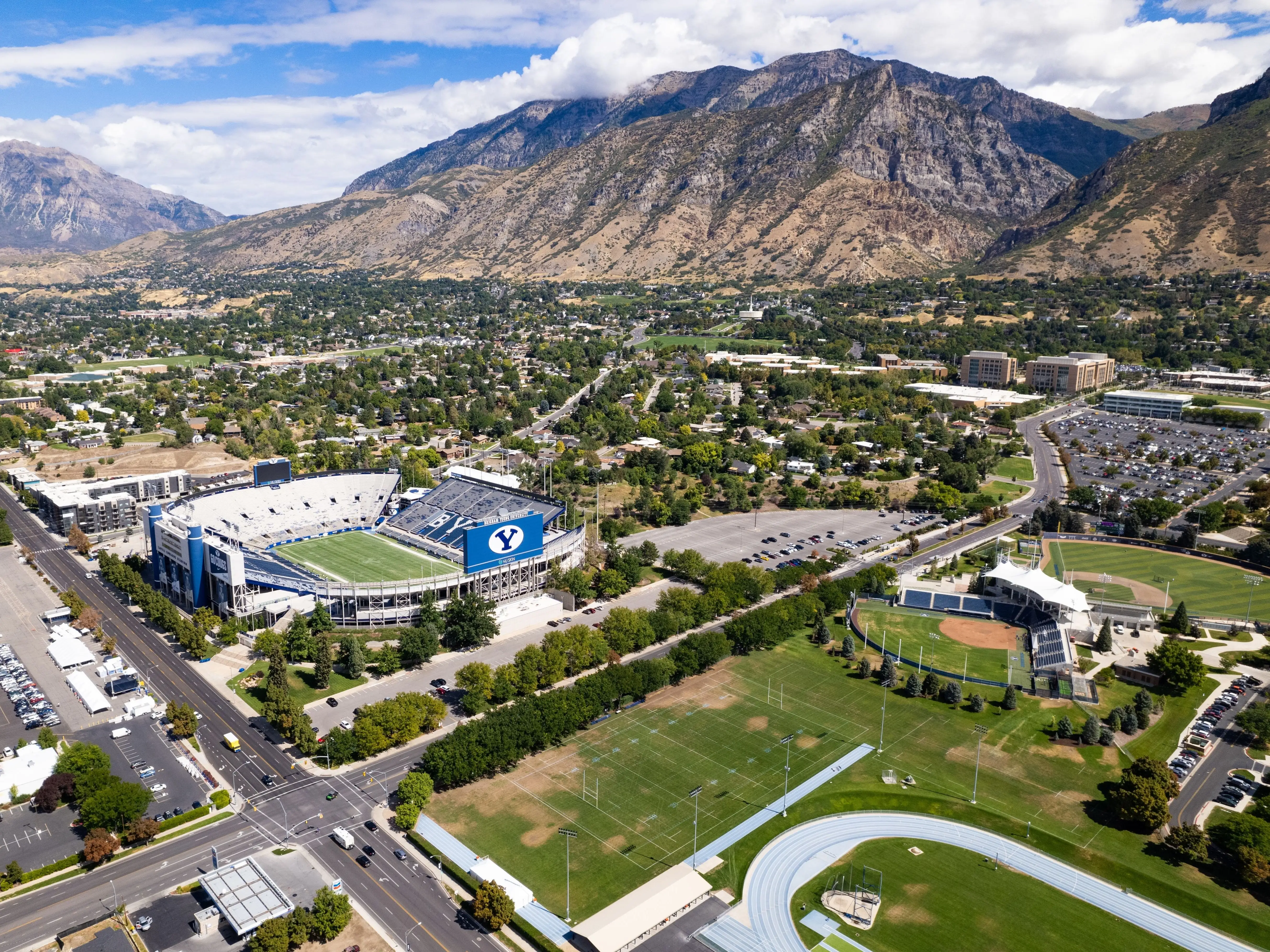 PROVO, UNITED STATES - Sep 15, 2022: Aerial view of Brigham Young University's Lavell Edwards Stadium  at base of Wasatch Range of rocky mountains, Provo, Utah