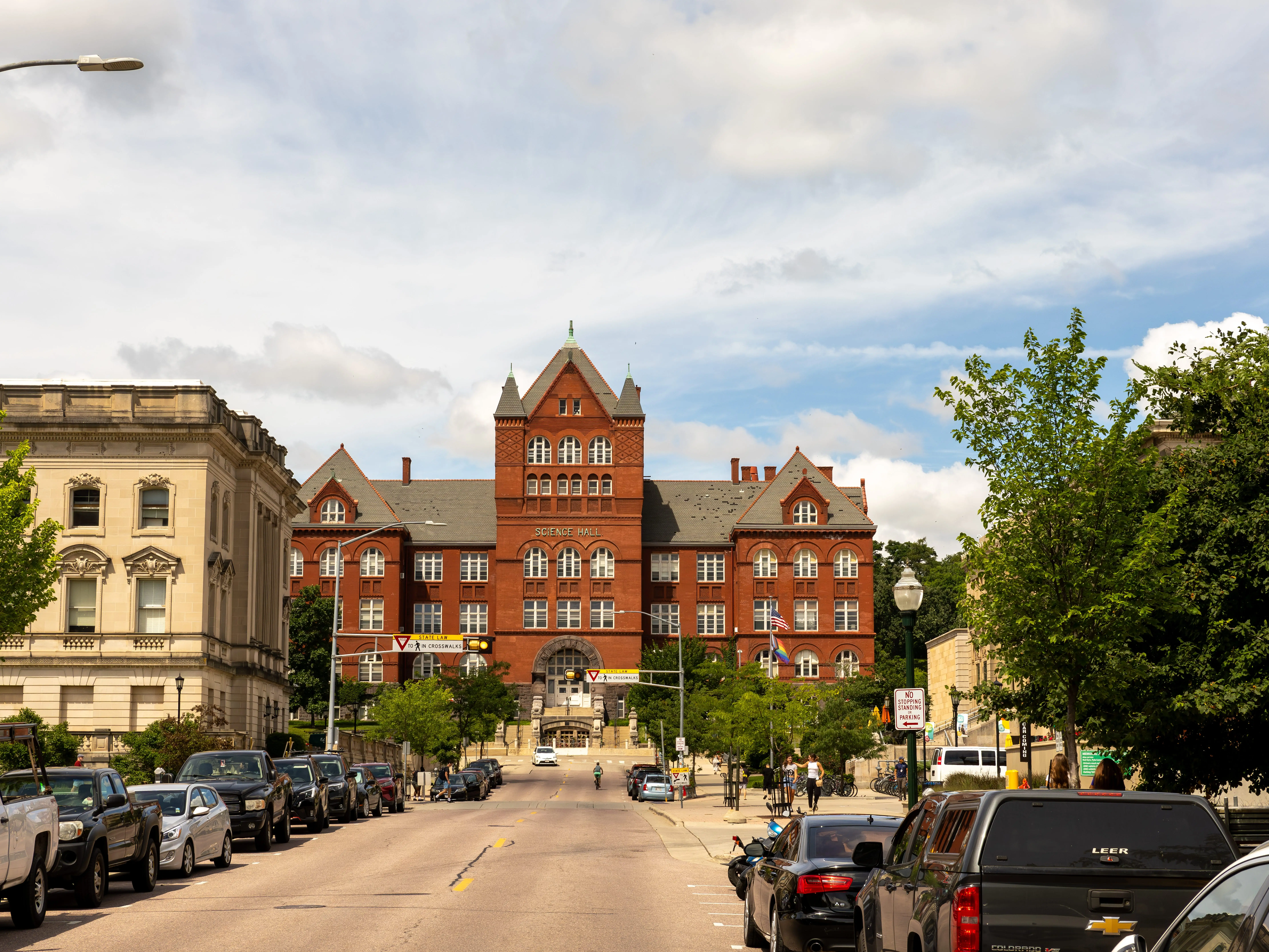 View looking up State Street to the Science Hall on the University of Wisconsin - Madison campus in Madison, Wisconsin, USA taken on July 8, 2024 with clouds and blue skies overhead.