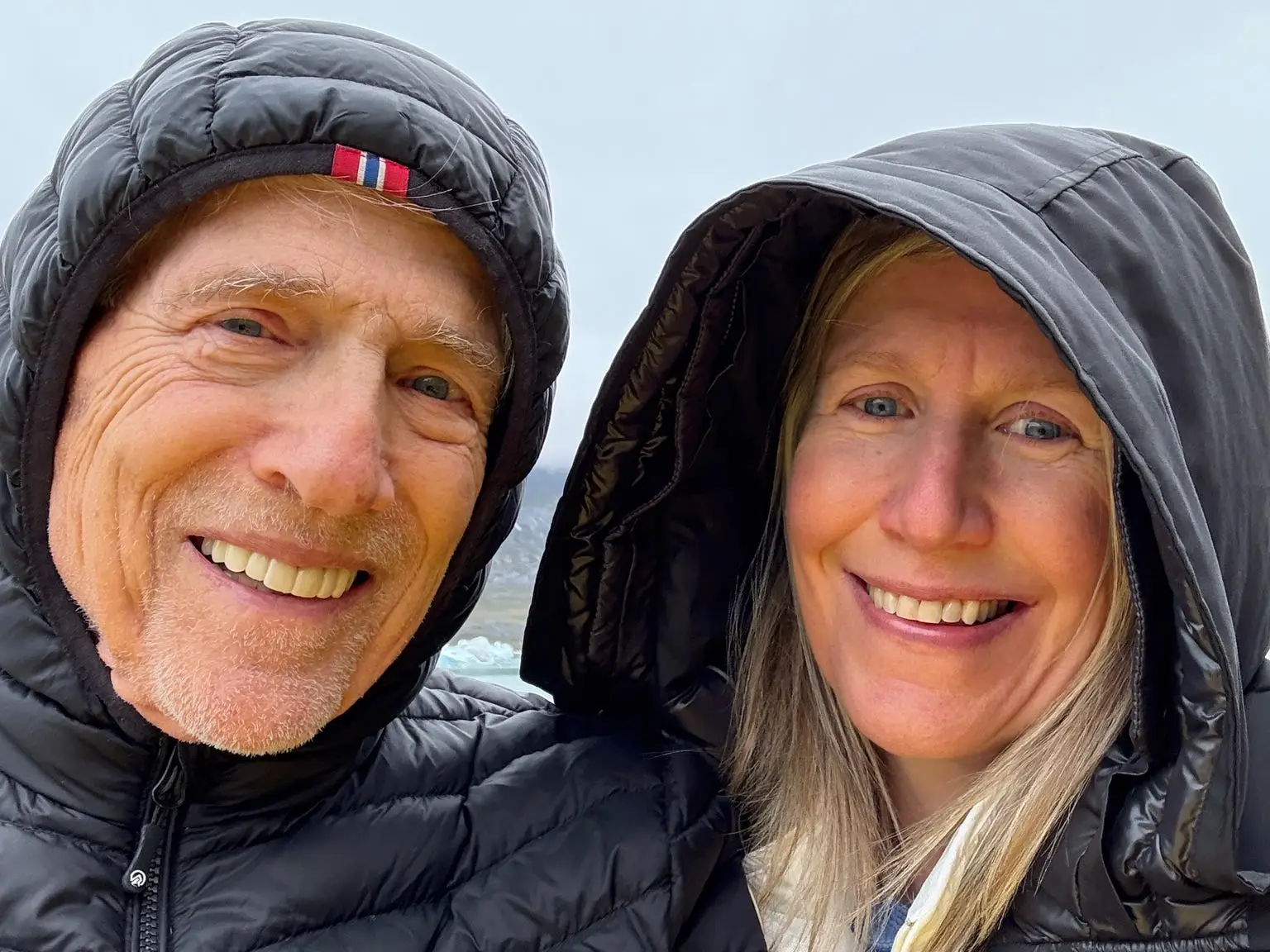 A selfie of a father and daughter while on a boat excursion in Greenland.