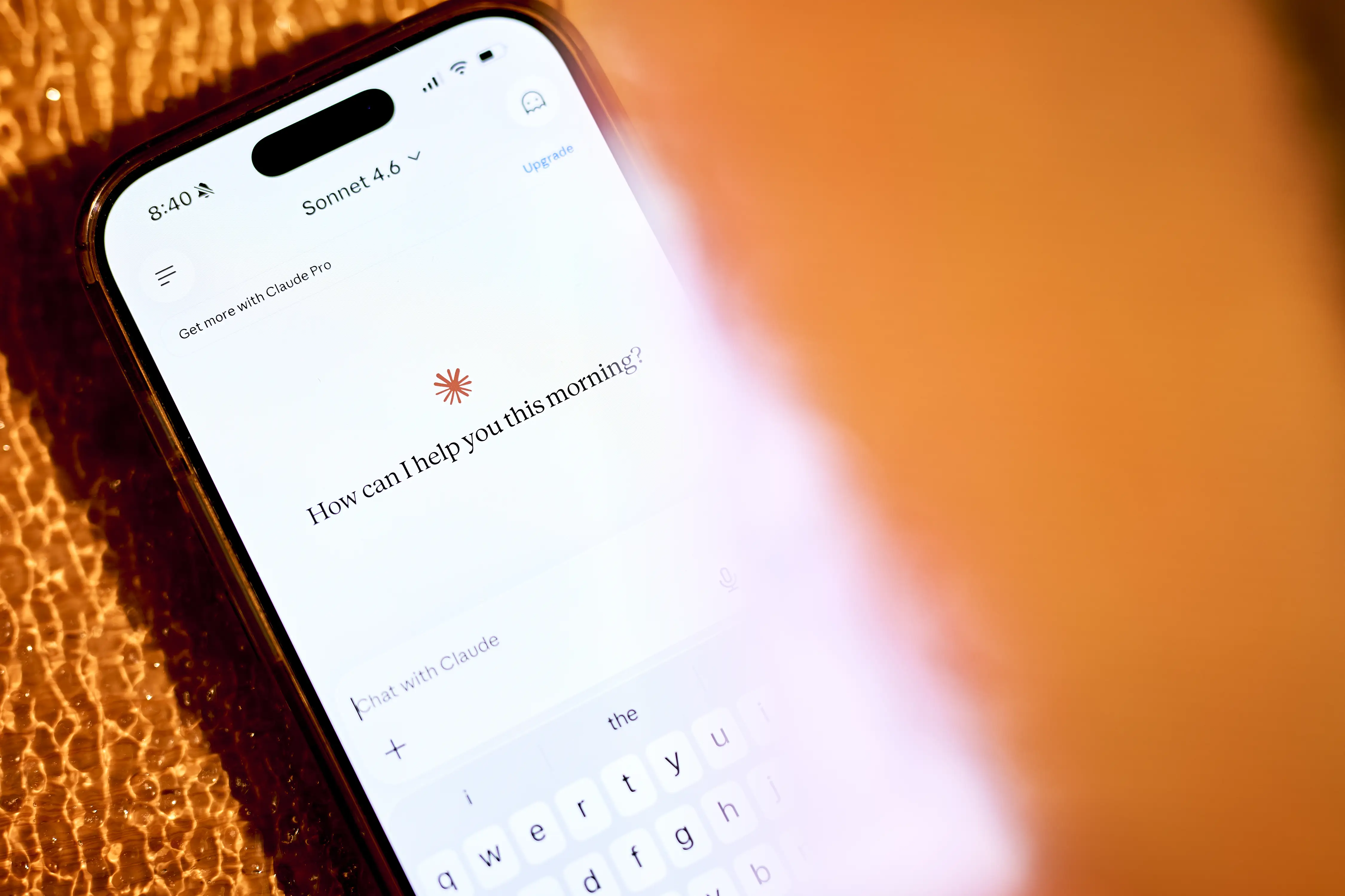 A smartphone displays the Claude AI interface.