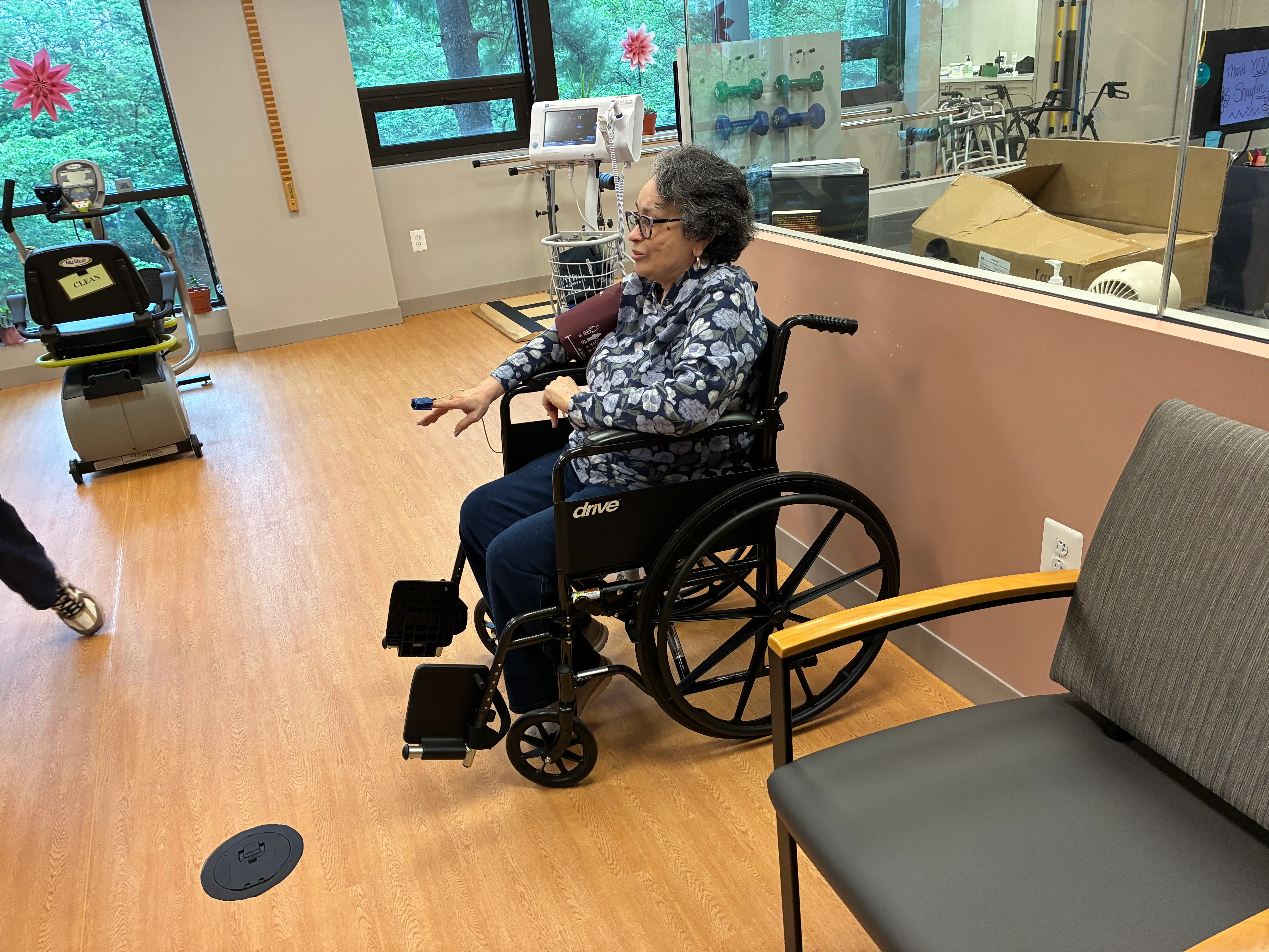 A woman in a wheelchair is having her blood pressure taken.