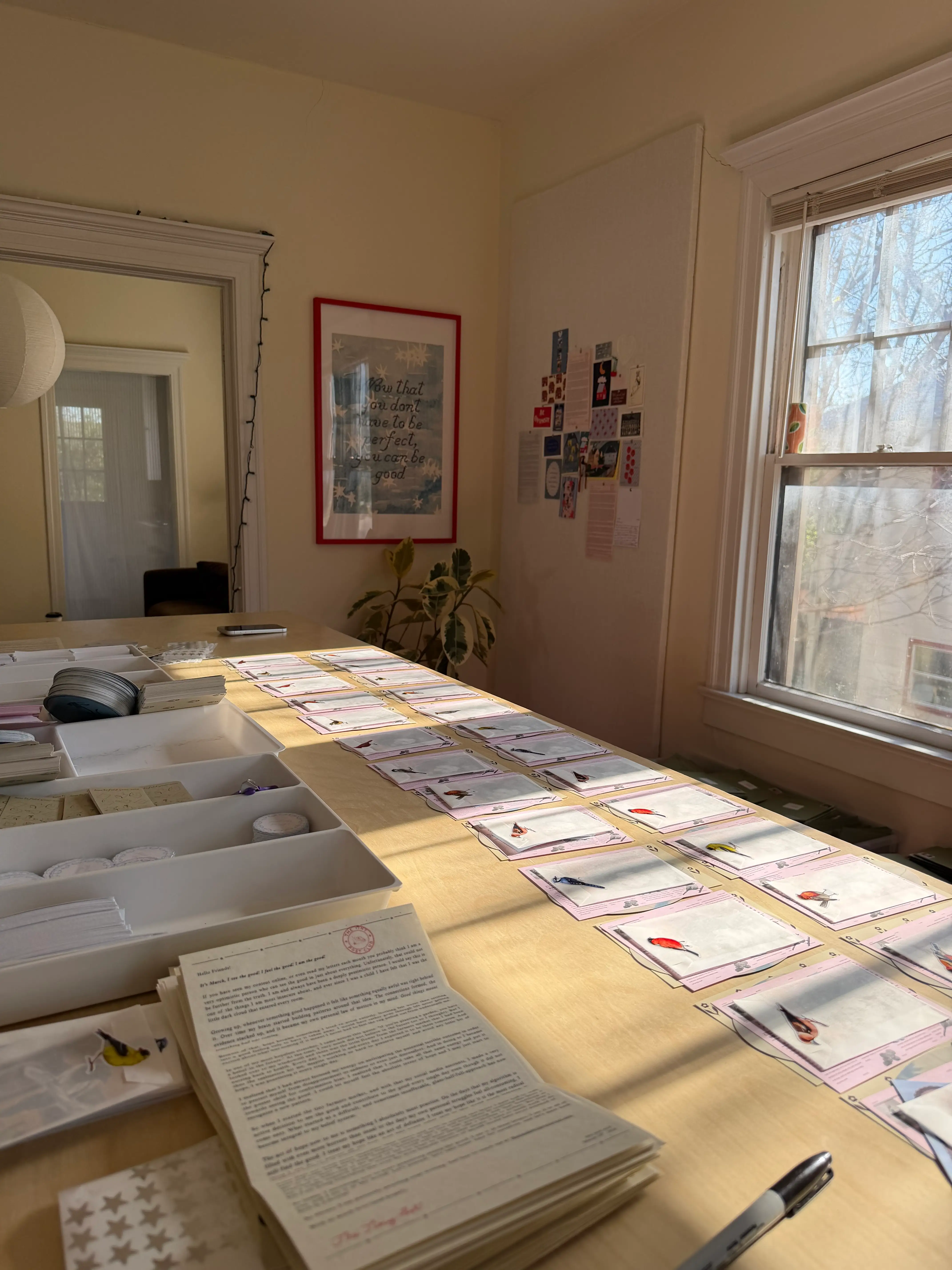 A table covered in letters and envelopes to be packed.