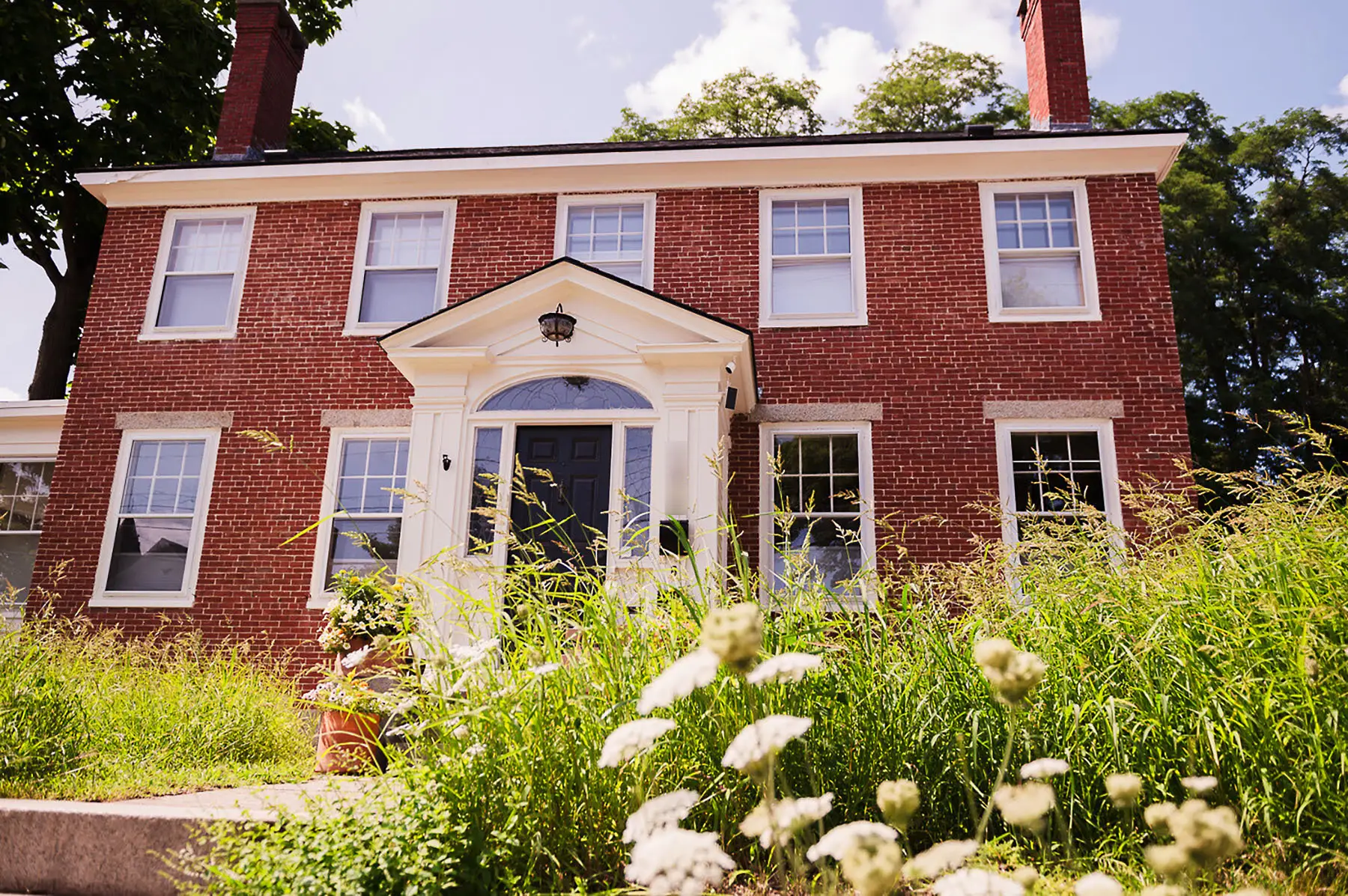 An exterior shot of the author's brick home.