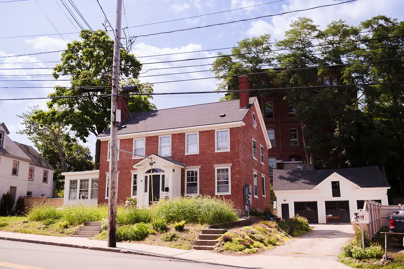 An exterior shot of the writer's house with a white garage attached.