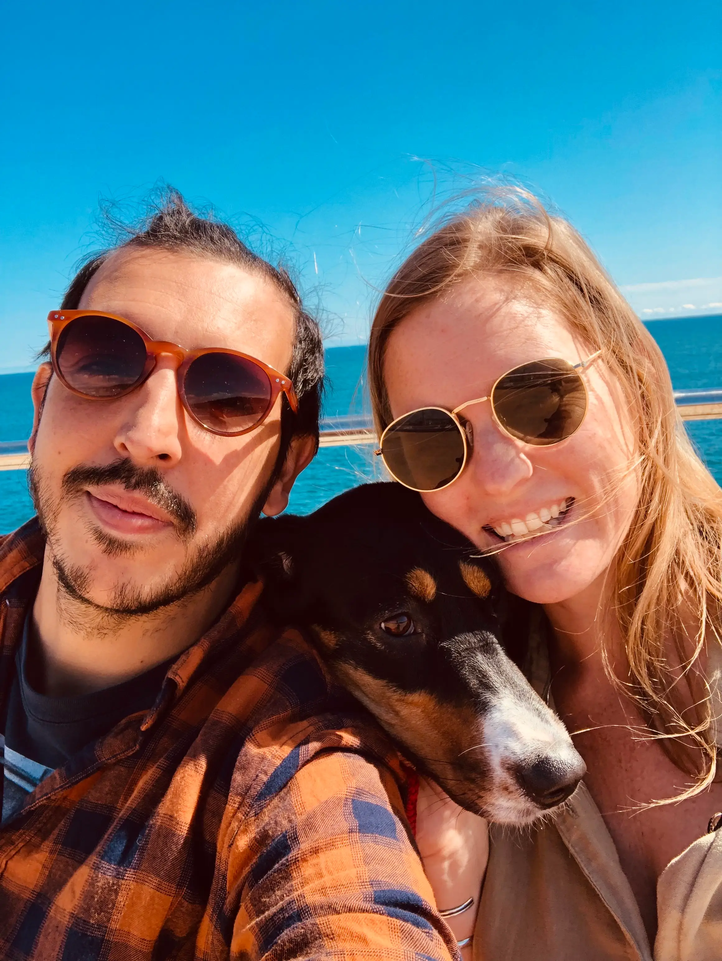 Author with her husband and dog, smiling