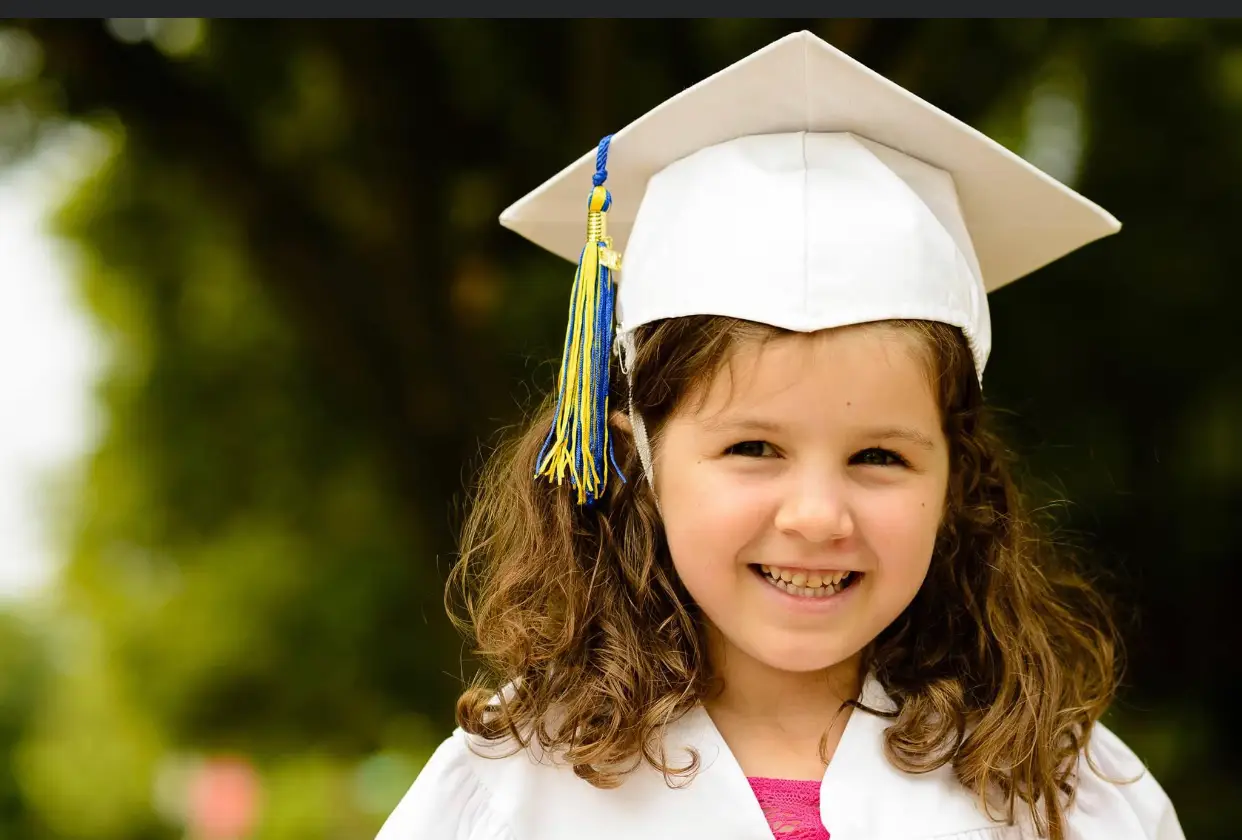 The author's daughter in a white cap and gown.