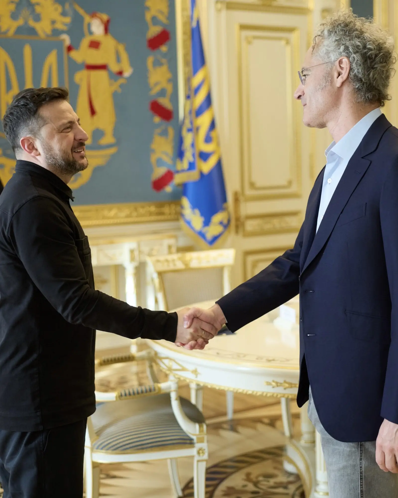 Ukrainian President Volodymyr Zelenskyy shakes hands with Palantir CEO Alex Karp