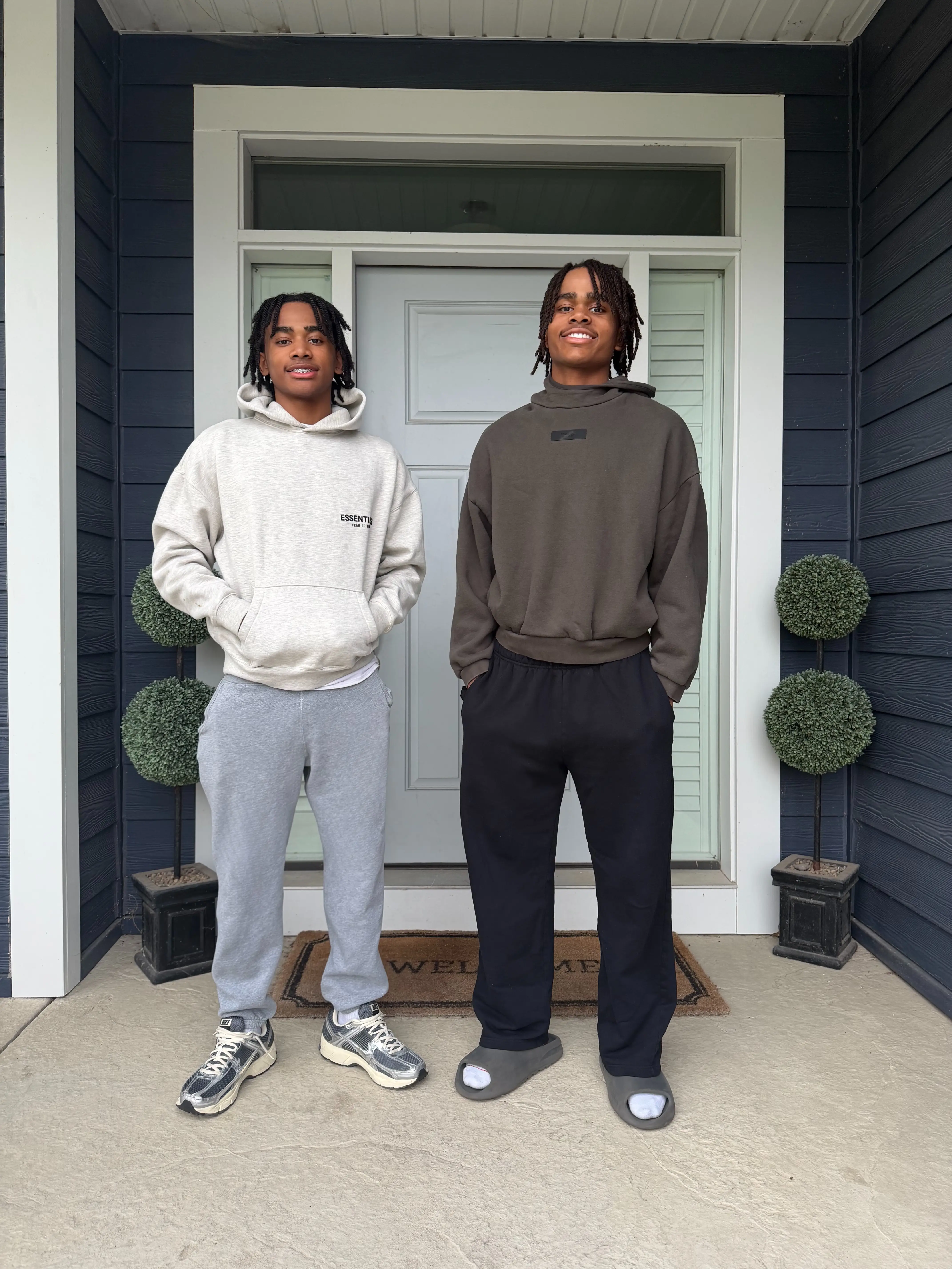 Julian Thomas and Timmy Thomas wear Essentials hoodies before a basketball tournament.