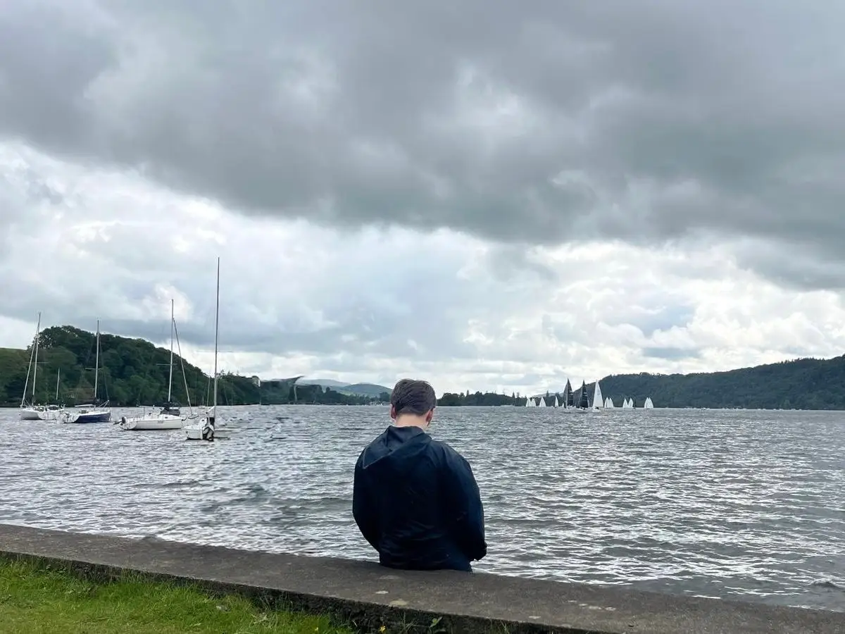 The author's son sitting at the edge of a lake.