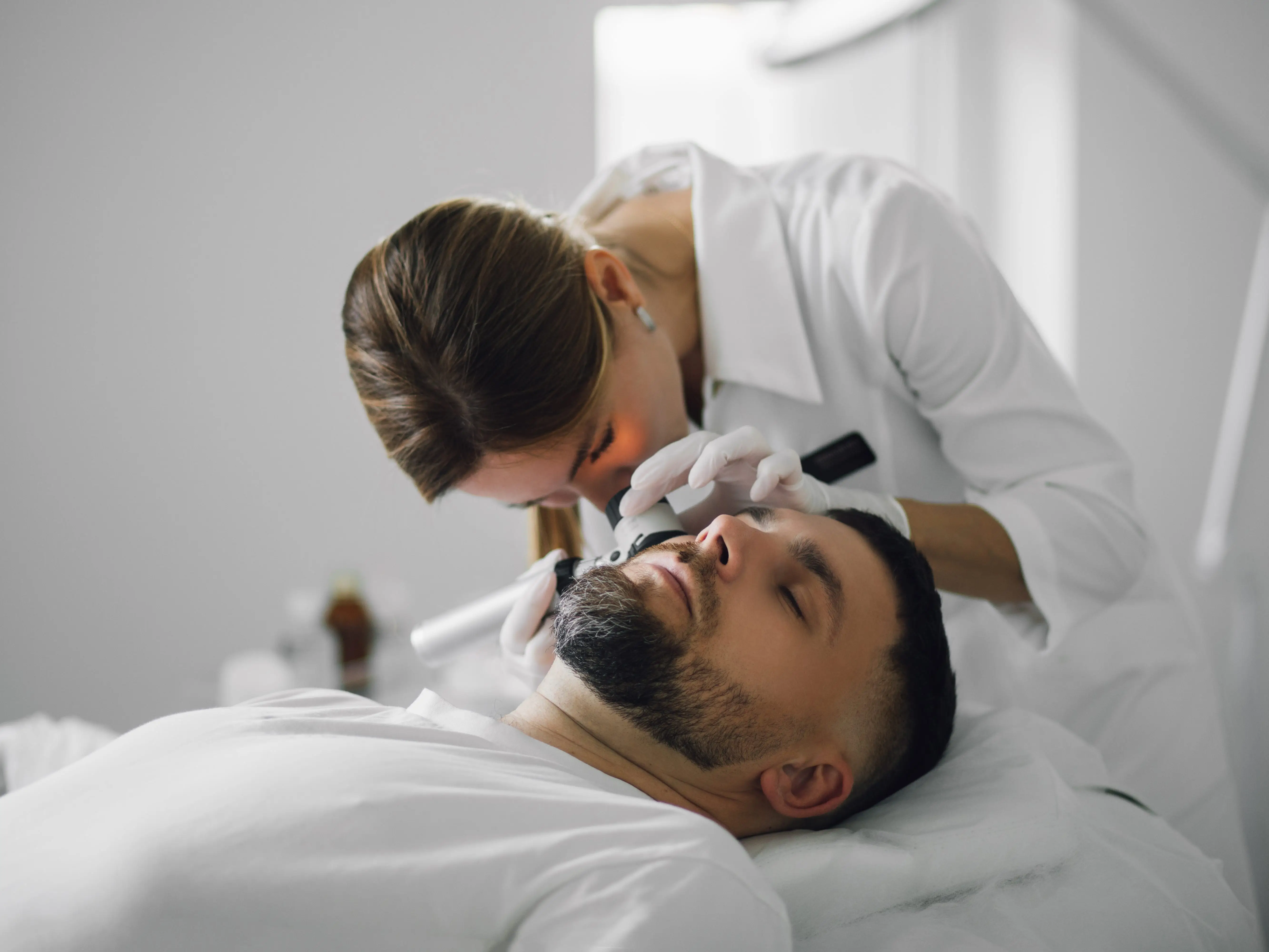 A dermatologist examining a patient