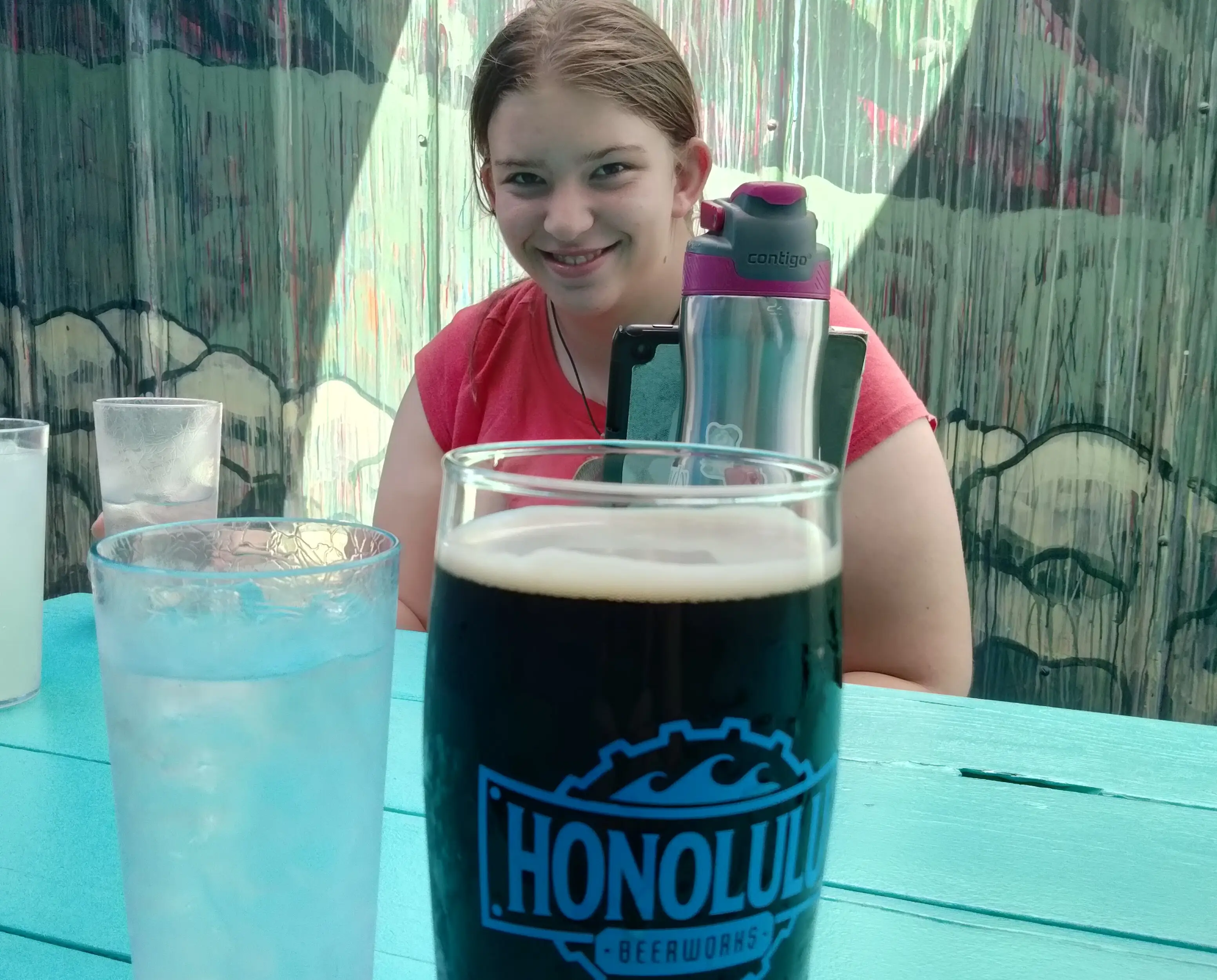 The authors daughter poses with a glass of water at a local bar.