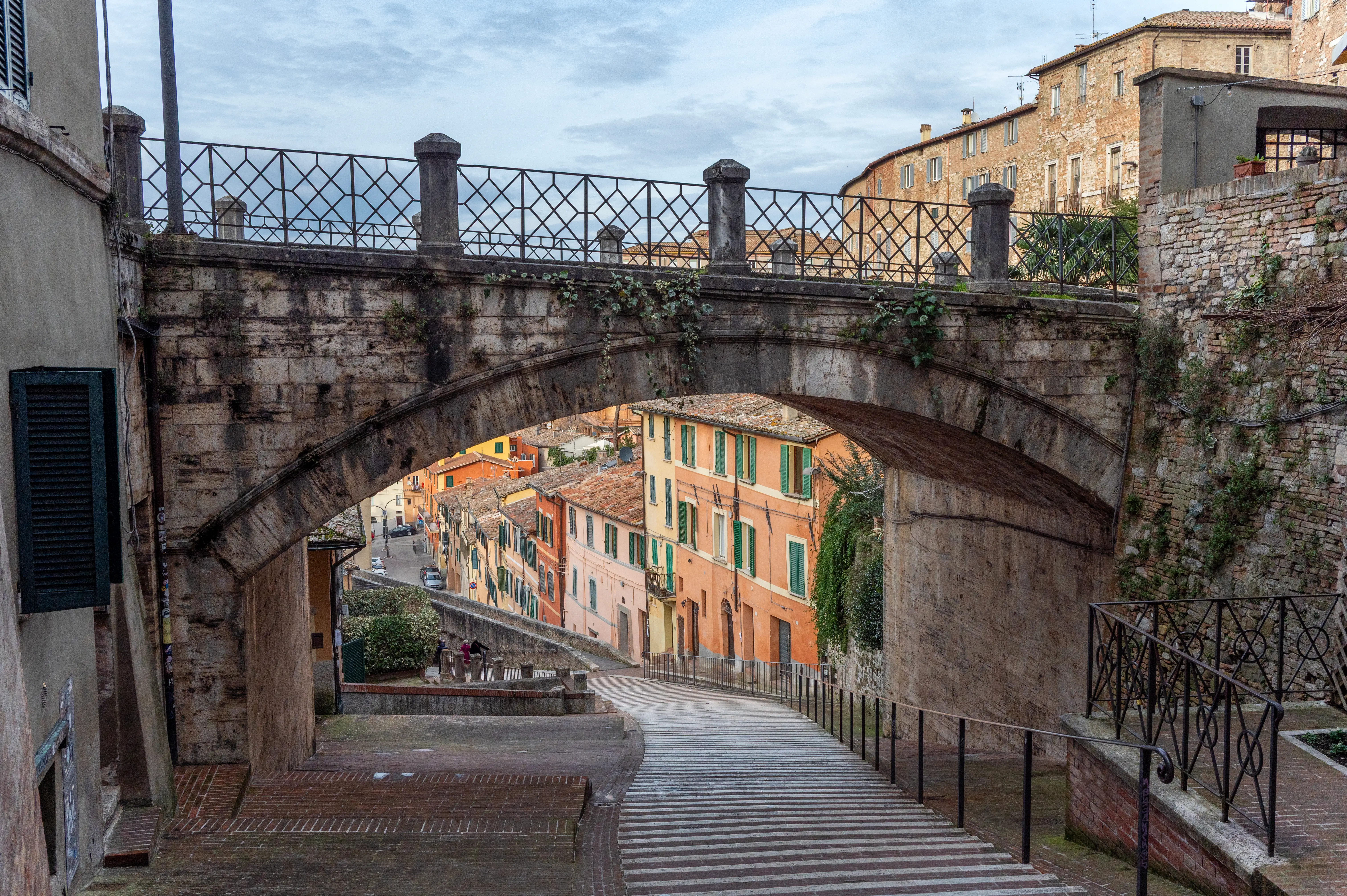 A bridge and colorful homes in Perugia, Italy.