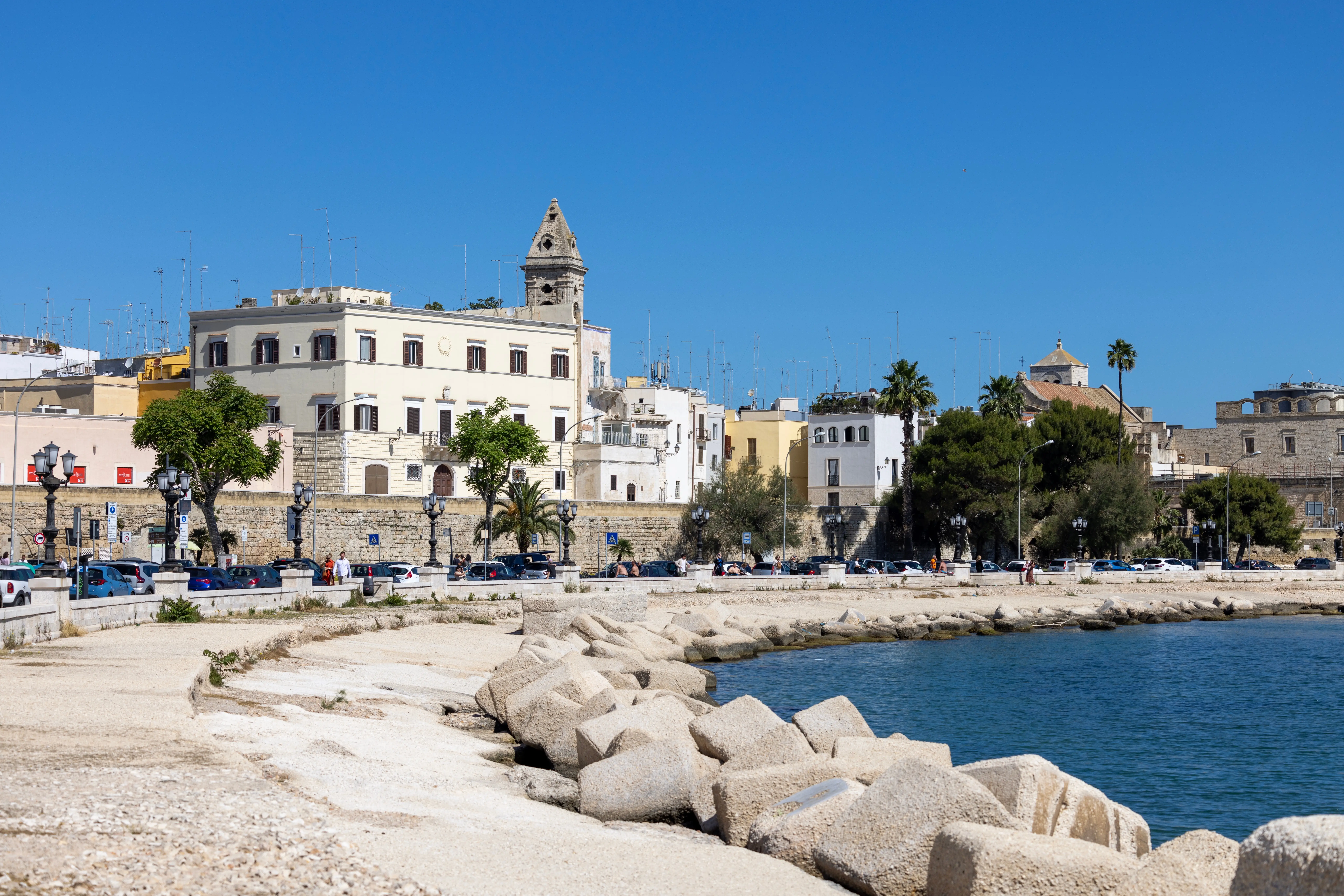 Blue water surrounded by white buildings in Bari, Italy.