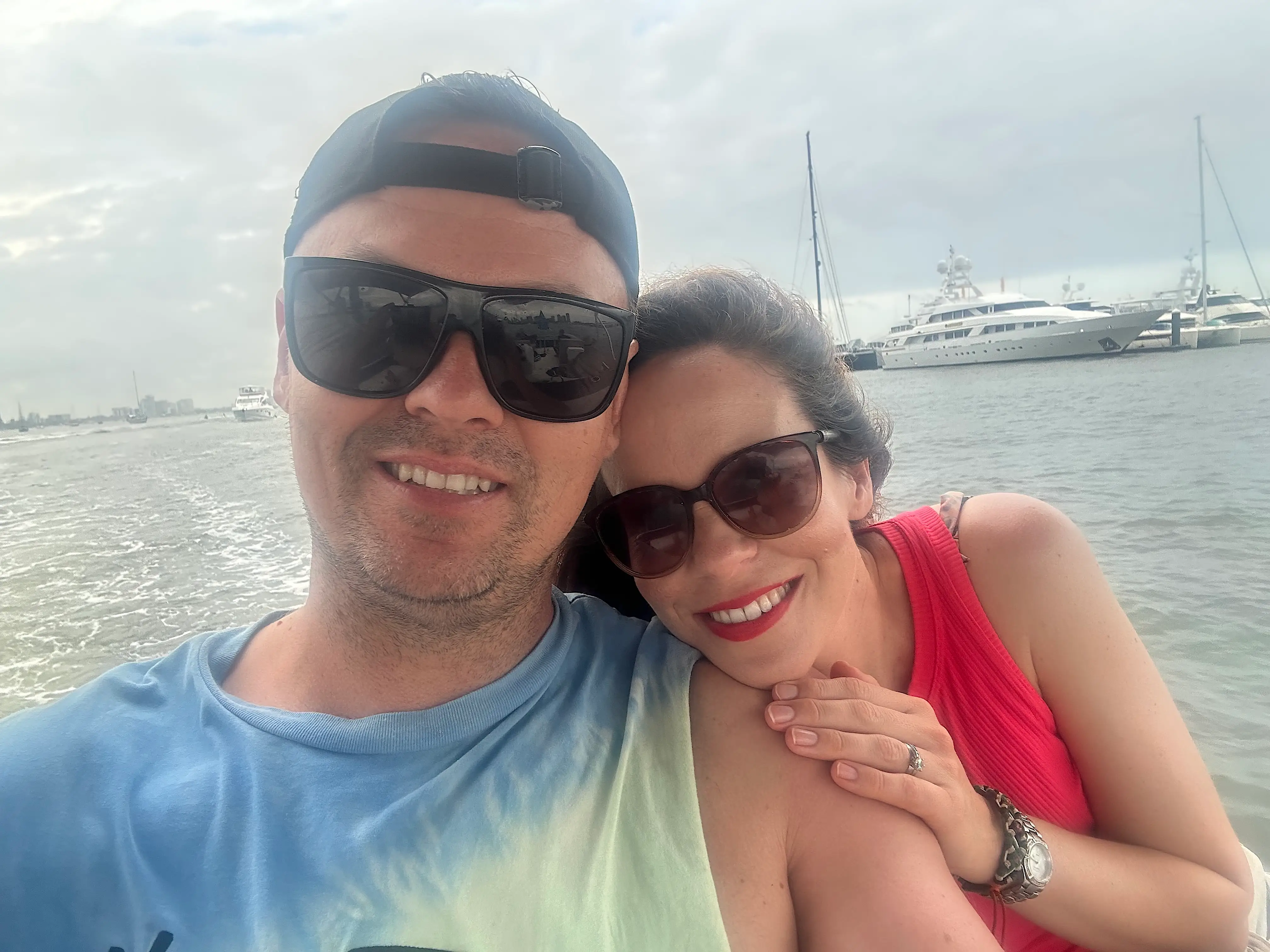 The author and her husband on a boat on the water of the Gold Coast.