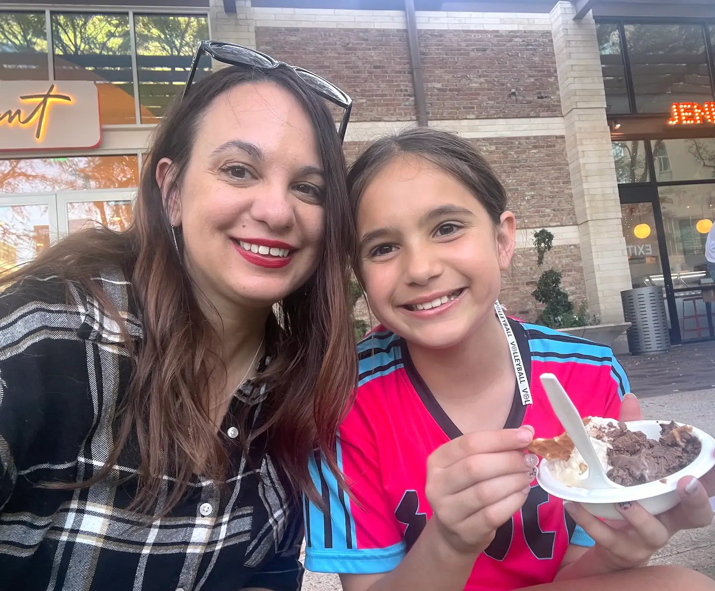 The author poses with her daughter while enjoying ice cream after a game.