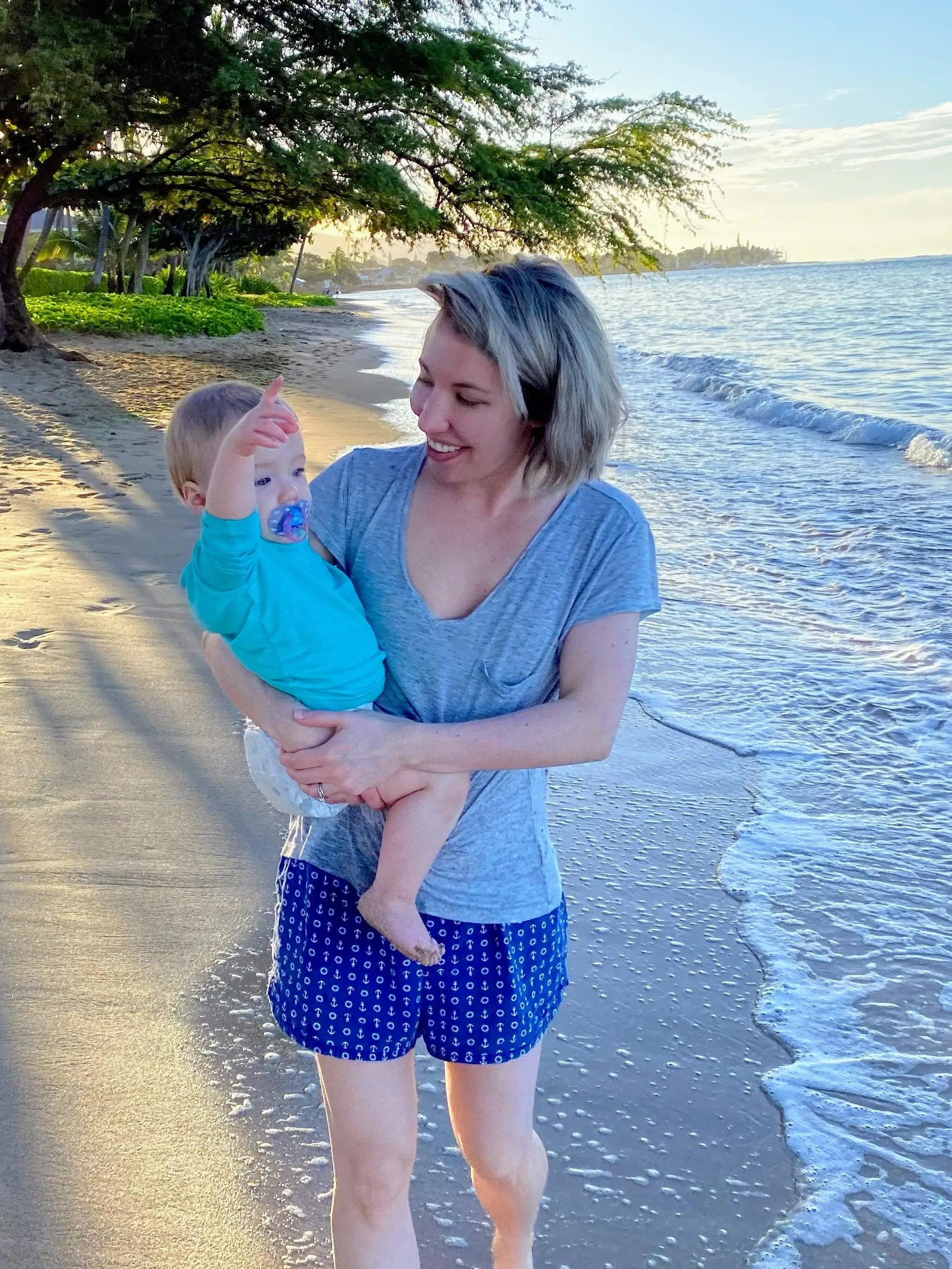 woman and baby on beach