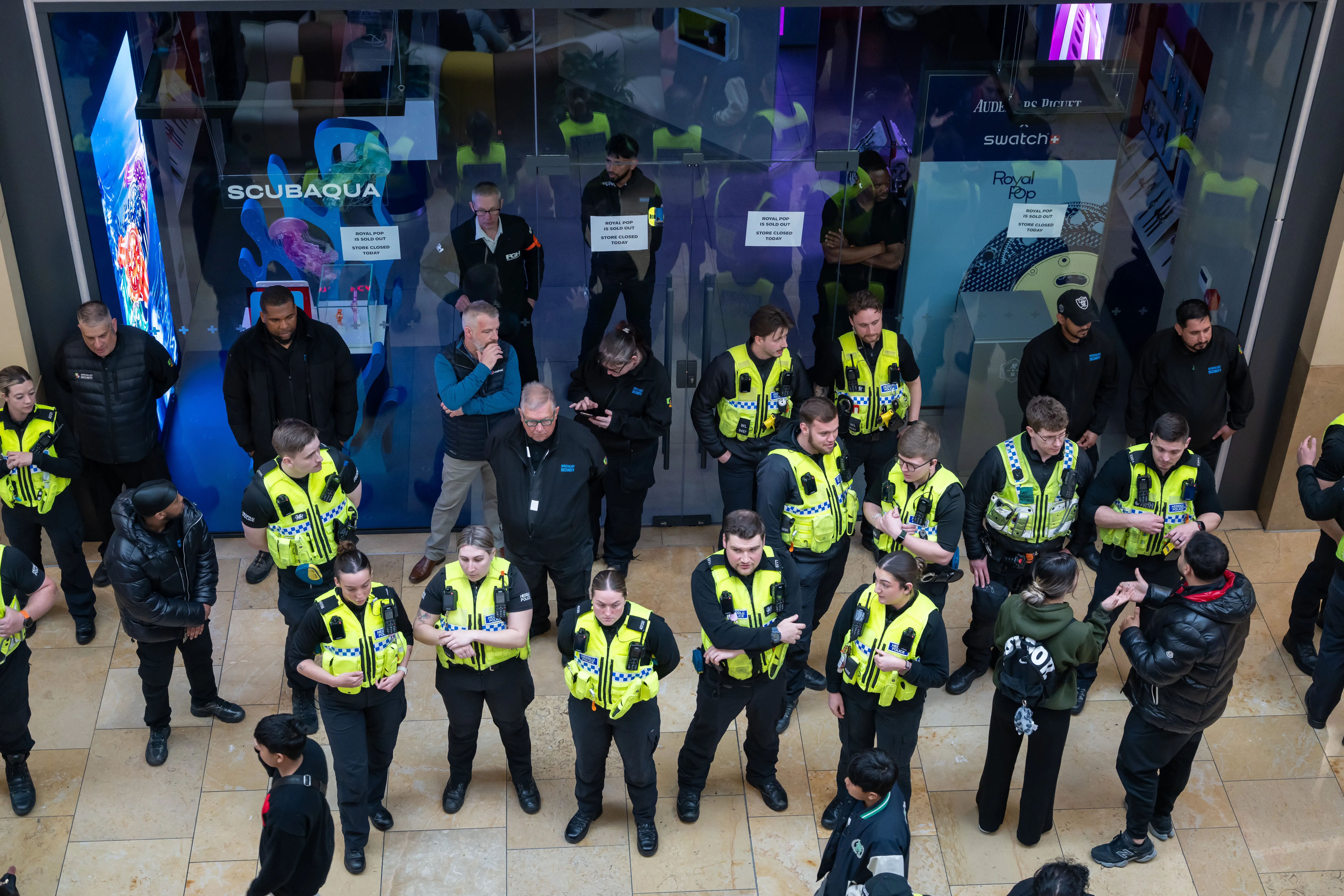 Police gather outside the Swatch store in St. Davids Shopping centre on May 16, 2026 in Cardiff, Wales. Swatch are today releasing the Swatch x Audemars Piguet Royal Pop pocket watch.