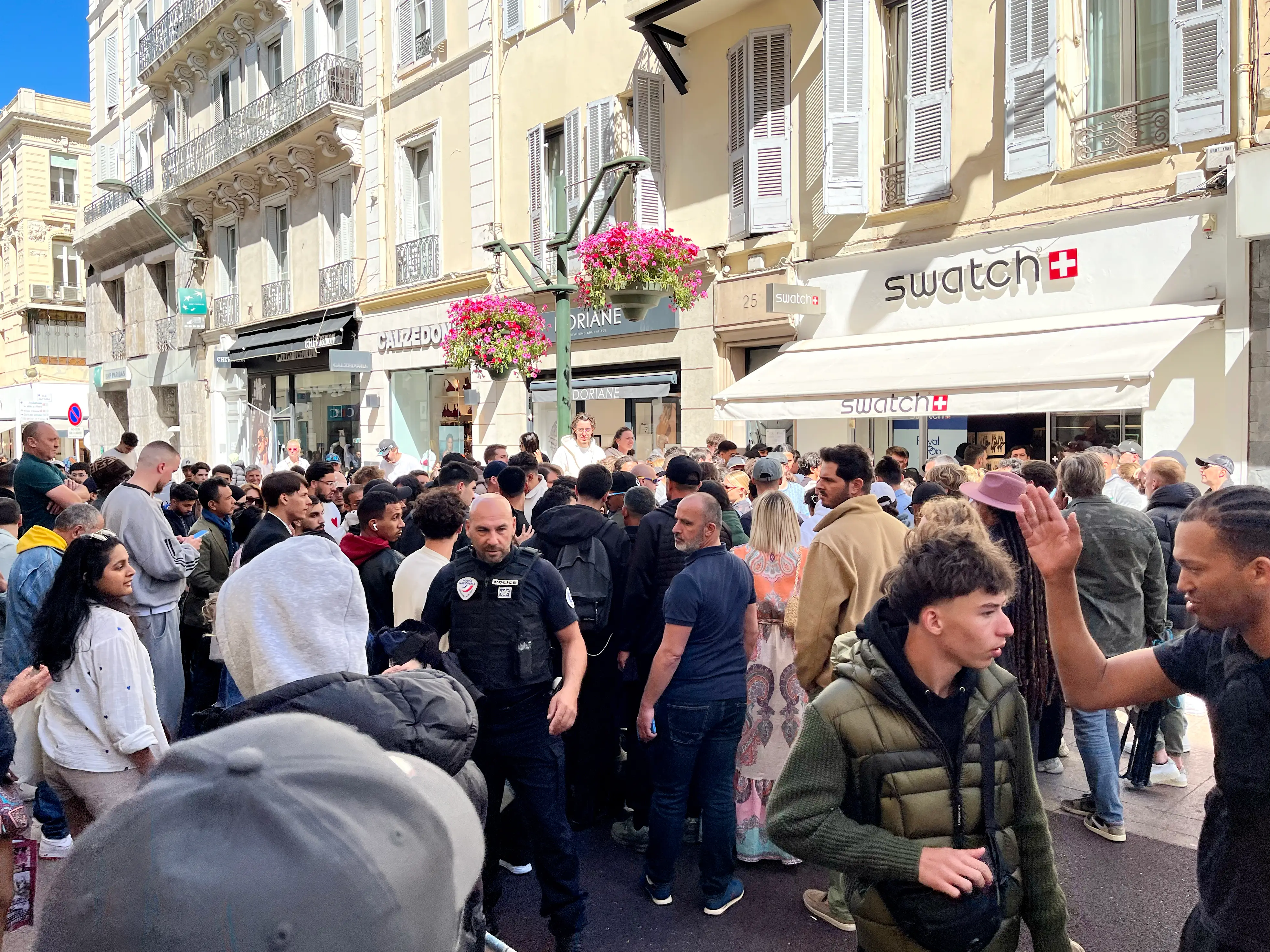 People queuing outside a Swatch Shop the day of the sales launch of the 