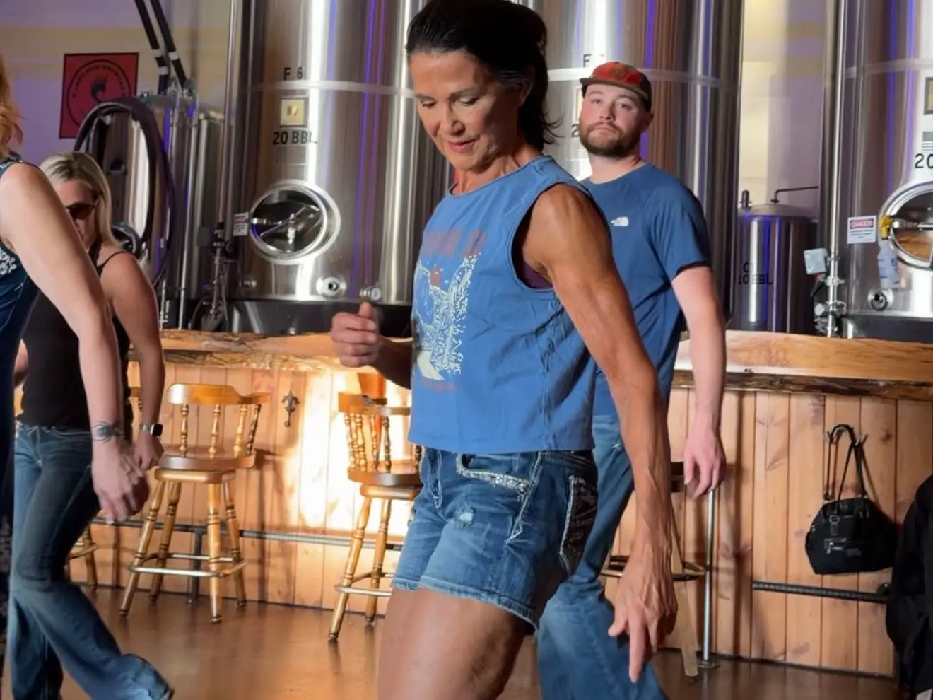 An older woman is line dancing.