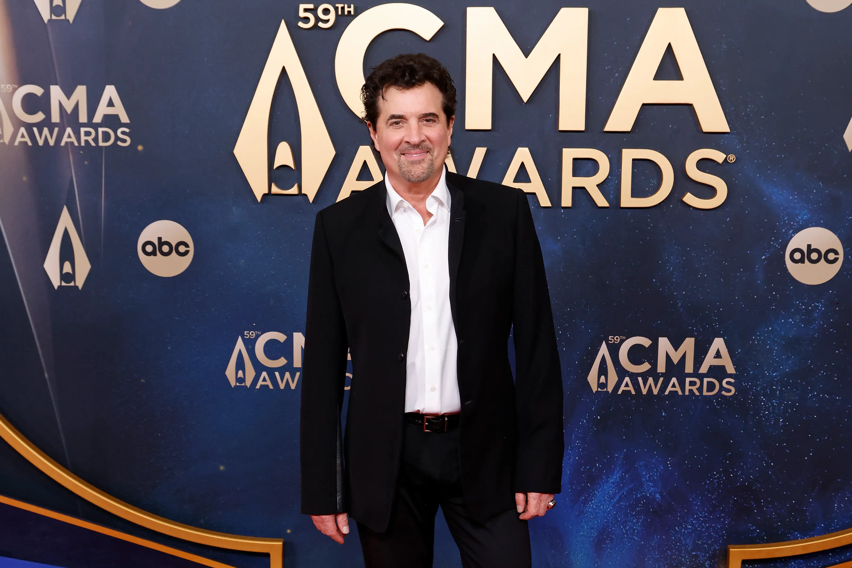 Scott Borchetta attends the 59th Annual CMA Awards at Music City Center wearing a suit.