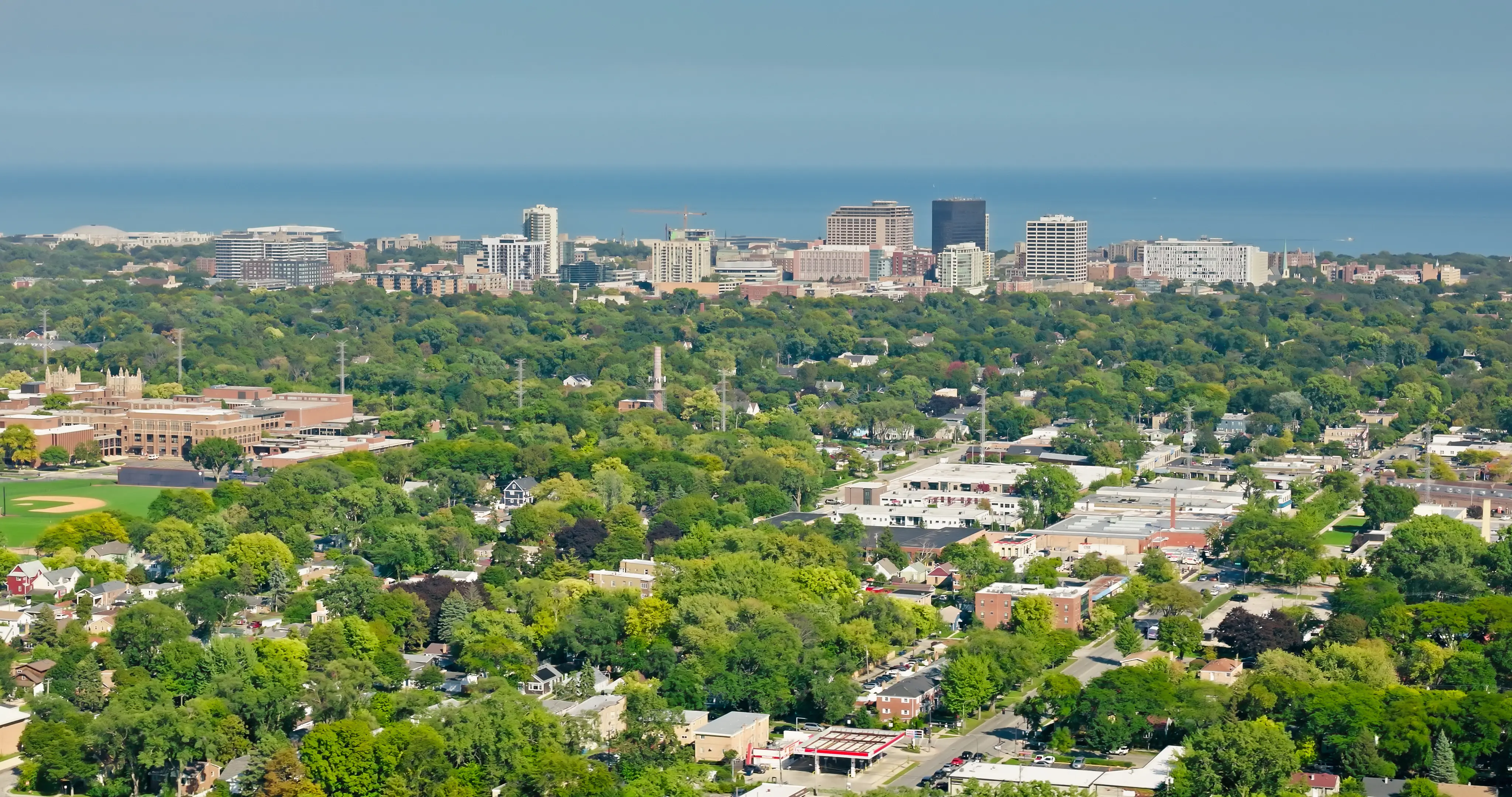 Aerial still of the Chicago skyline from over rooftops in Skokie, Illinois, on a clear day.