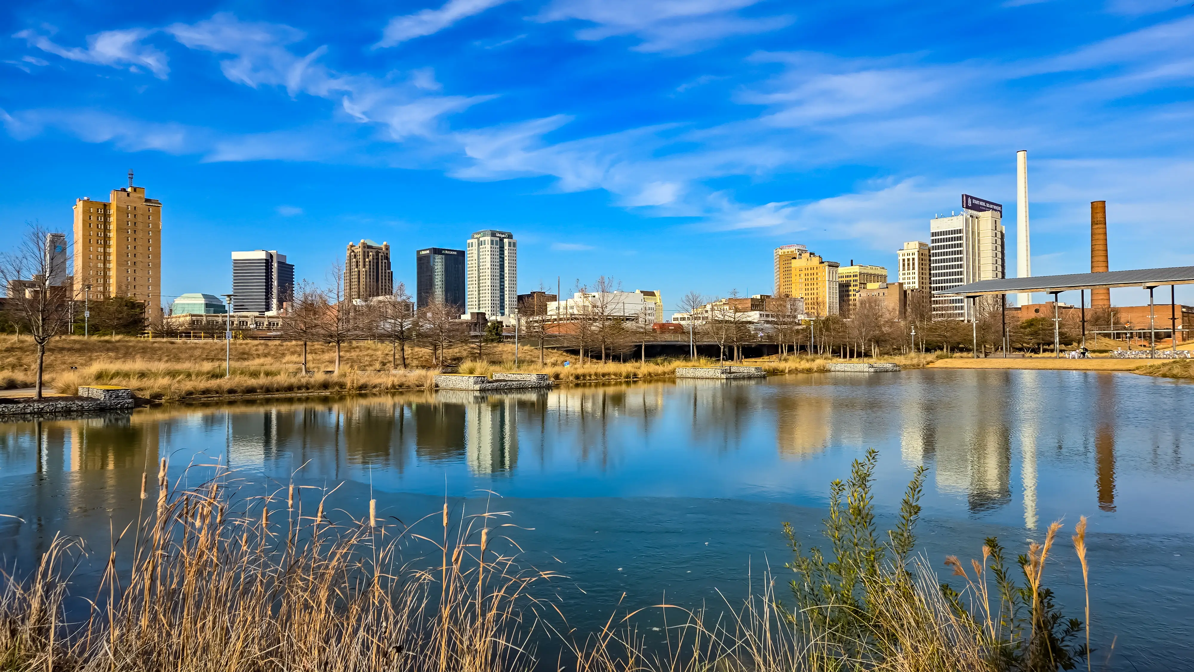 A lake in front of the Birmingham, Alabama, skyline.