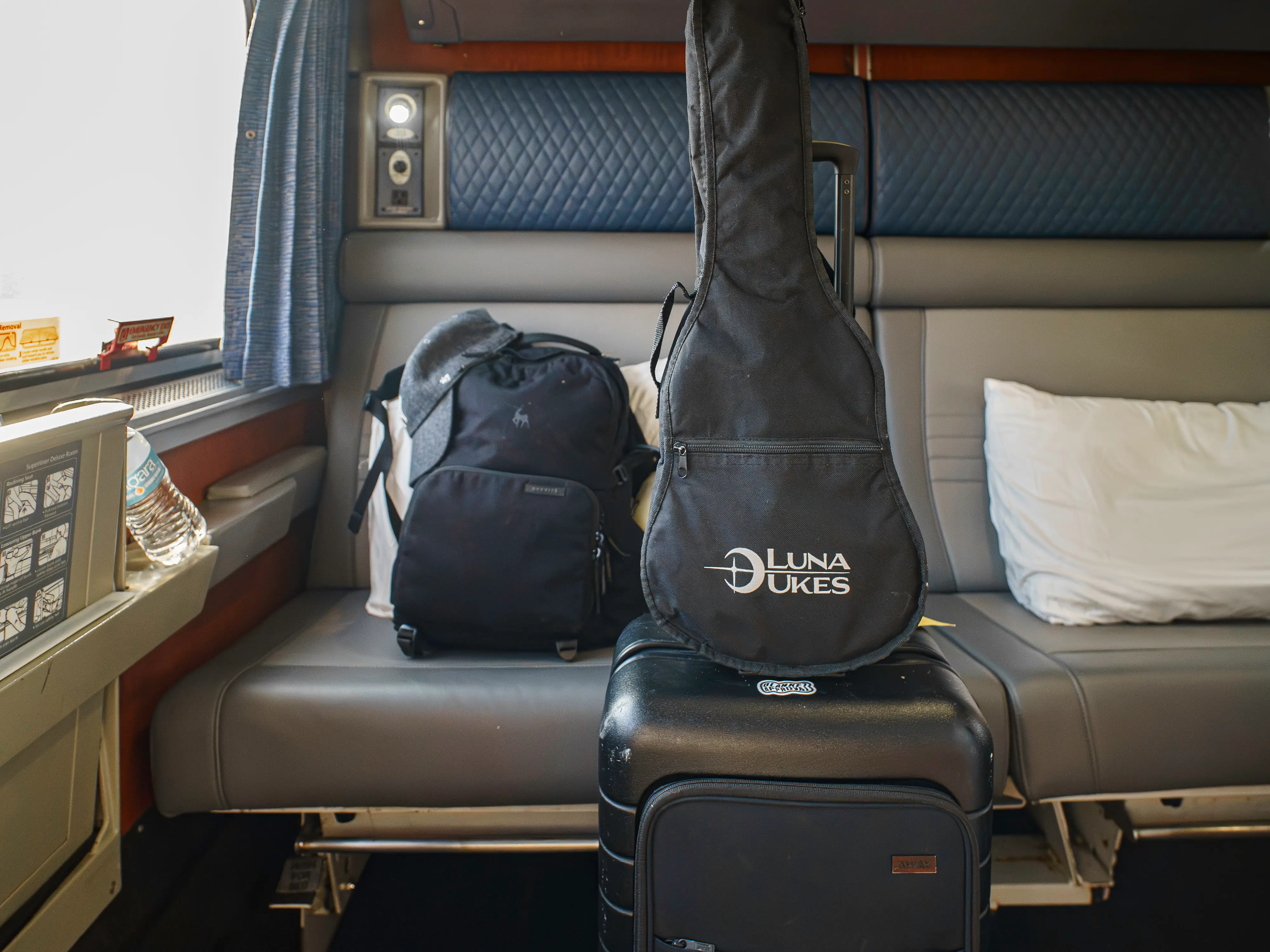 The author's packed bags in front of a couch in an Amtrak bedroom