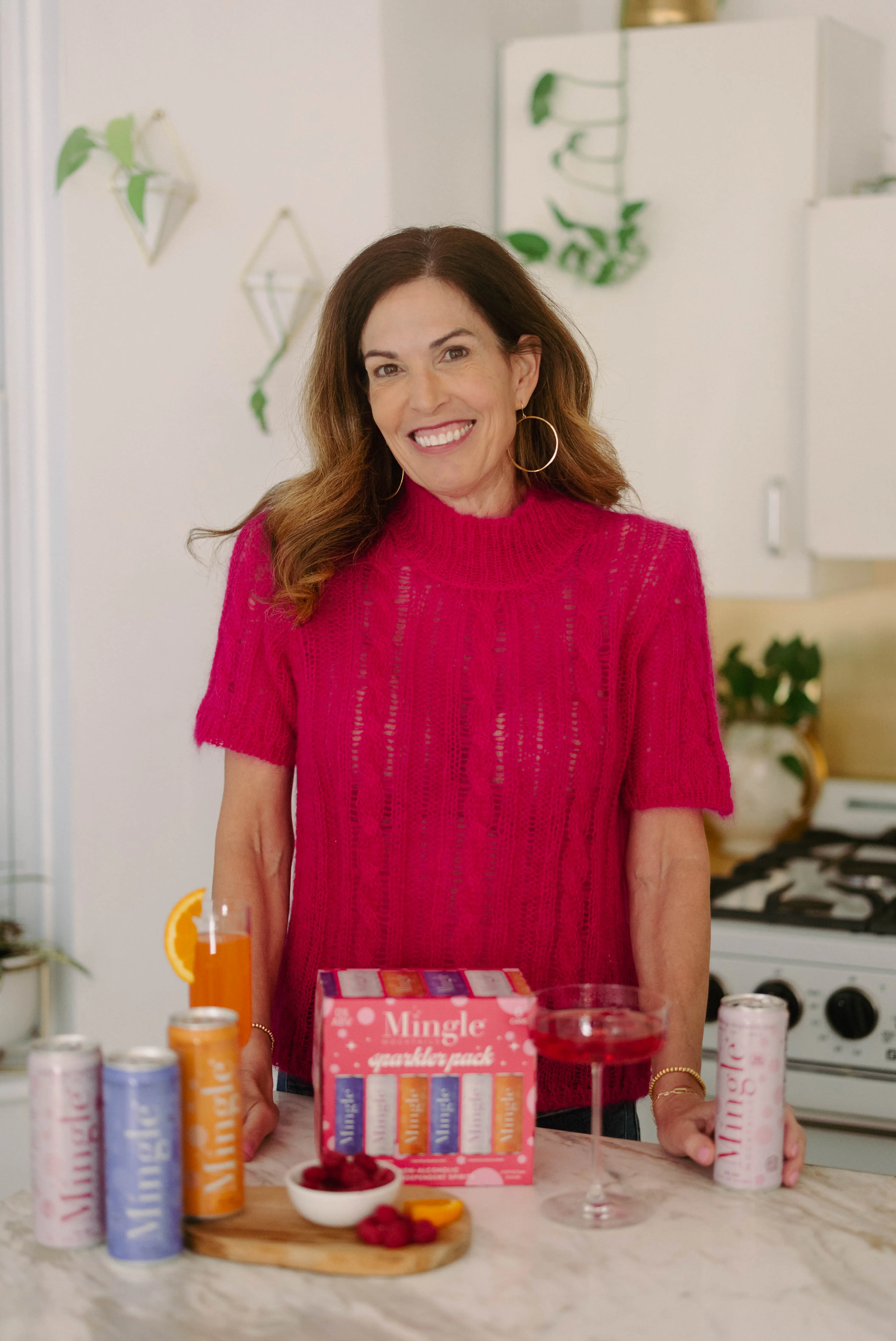 the CEO of Mingle Mocktails poses with her product