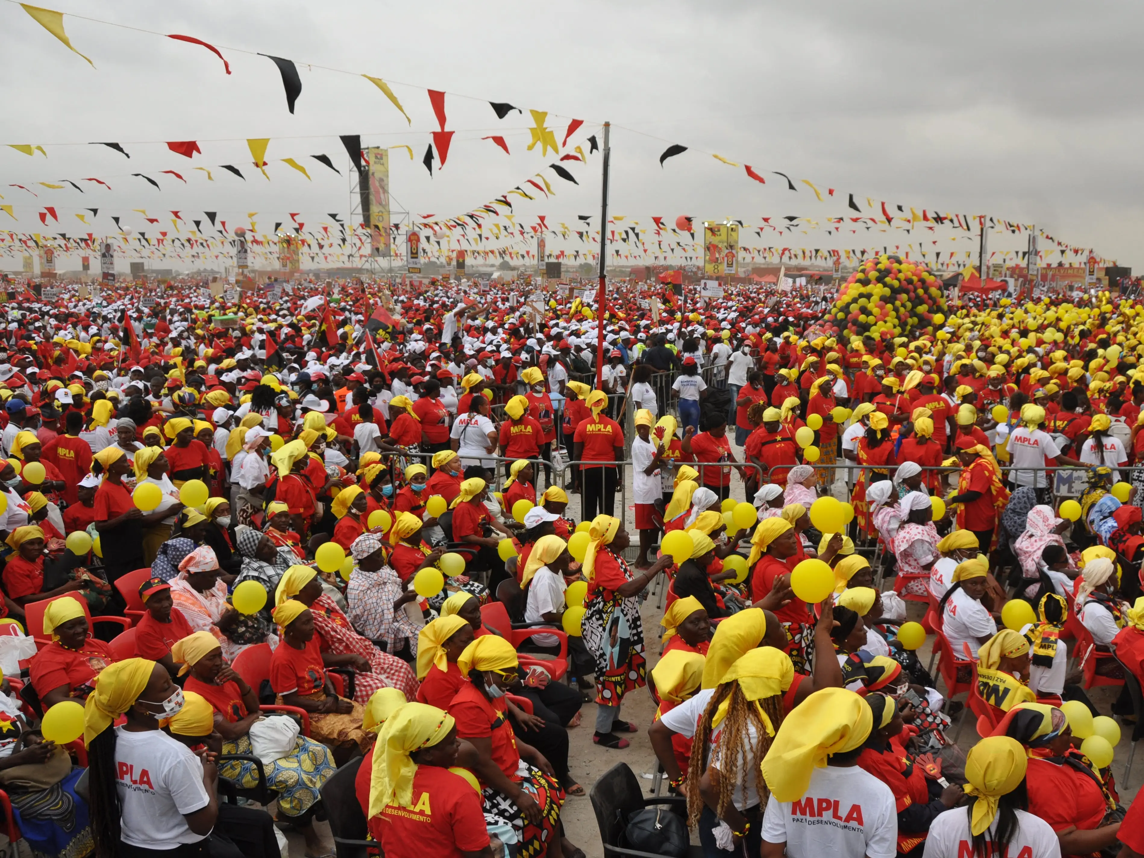 A crowd wearing matching attire for a political rally in Luanda, Angola.