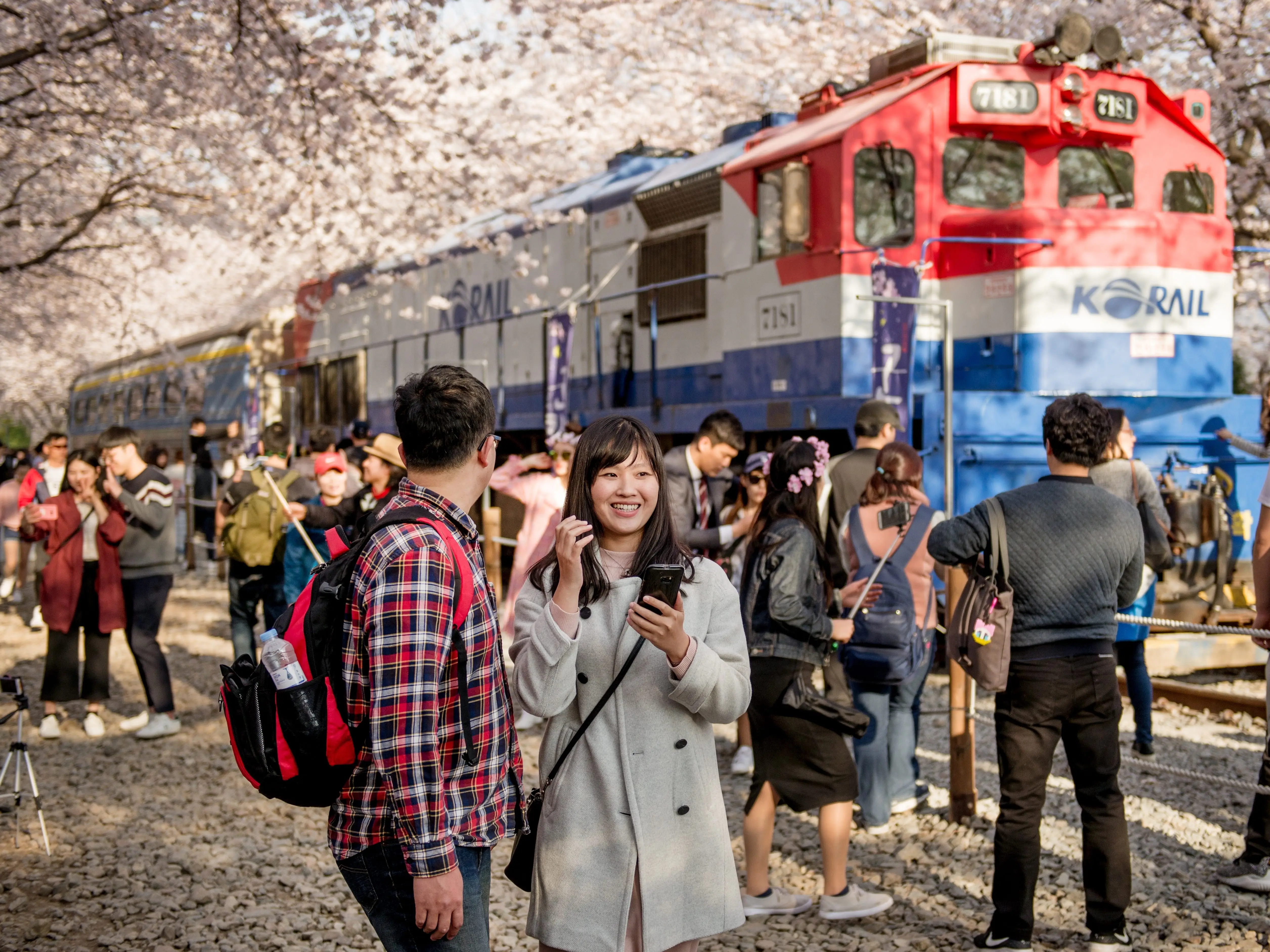 Crowd of people outside a train in Chinhae, South Korea.