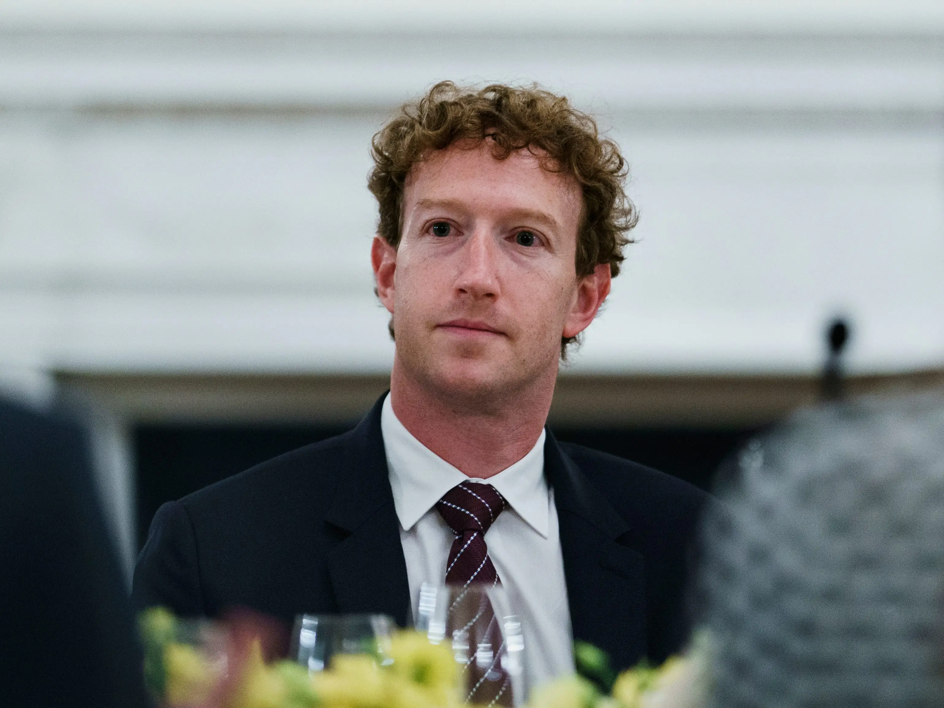 Mark Zuckerberg sitting in suit