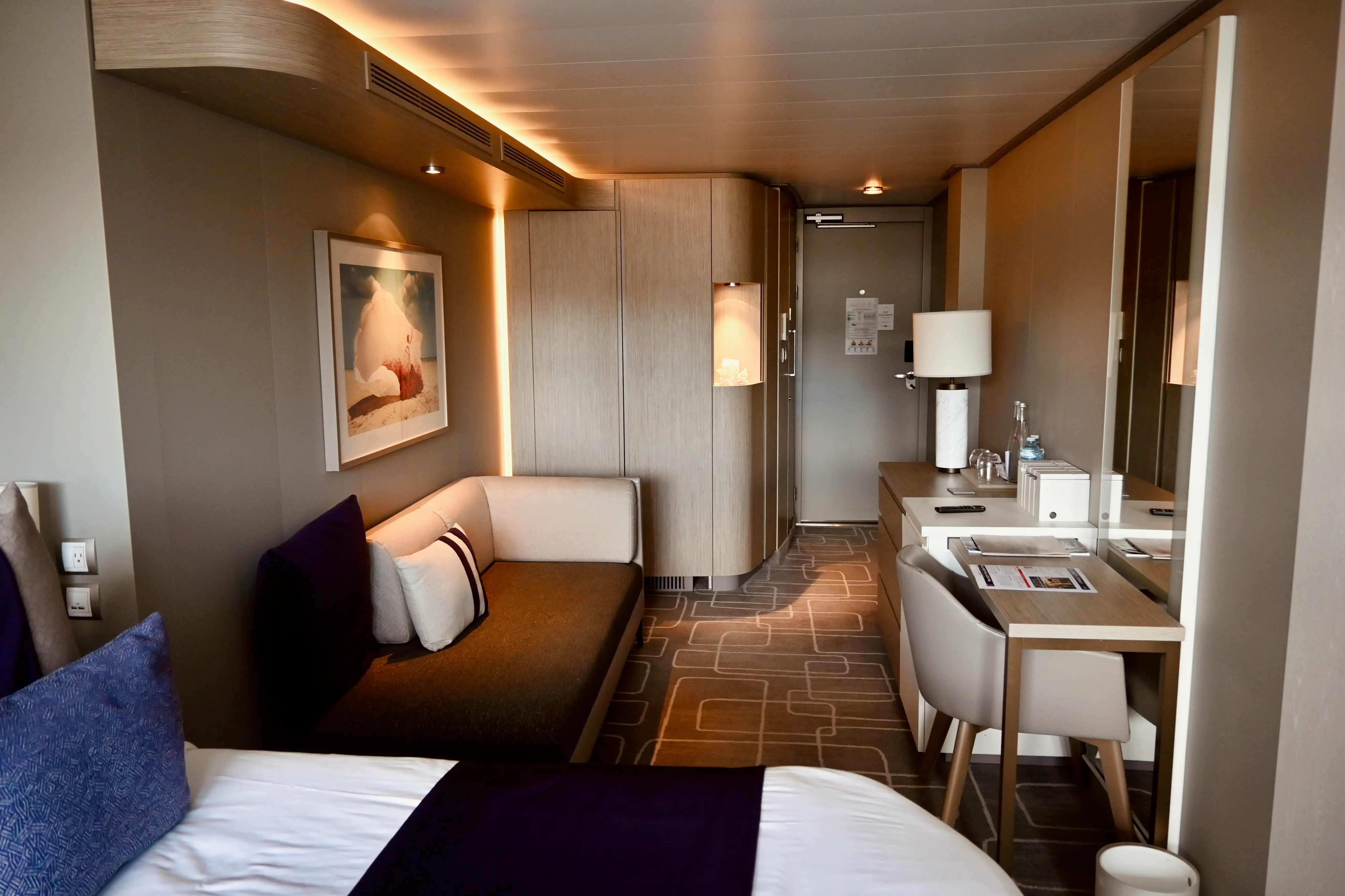 Interior of Infinite Veranda cabin on Celebrity cruise: Couch, dsk, edge of bed, entrance