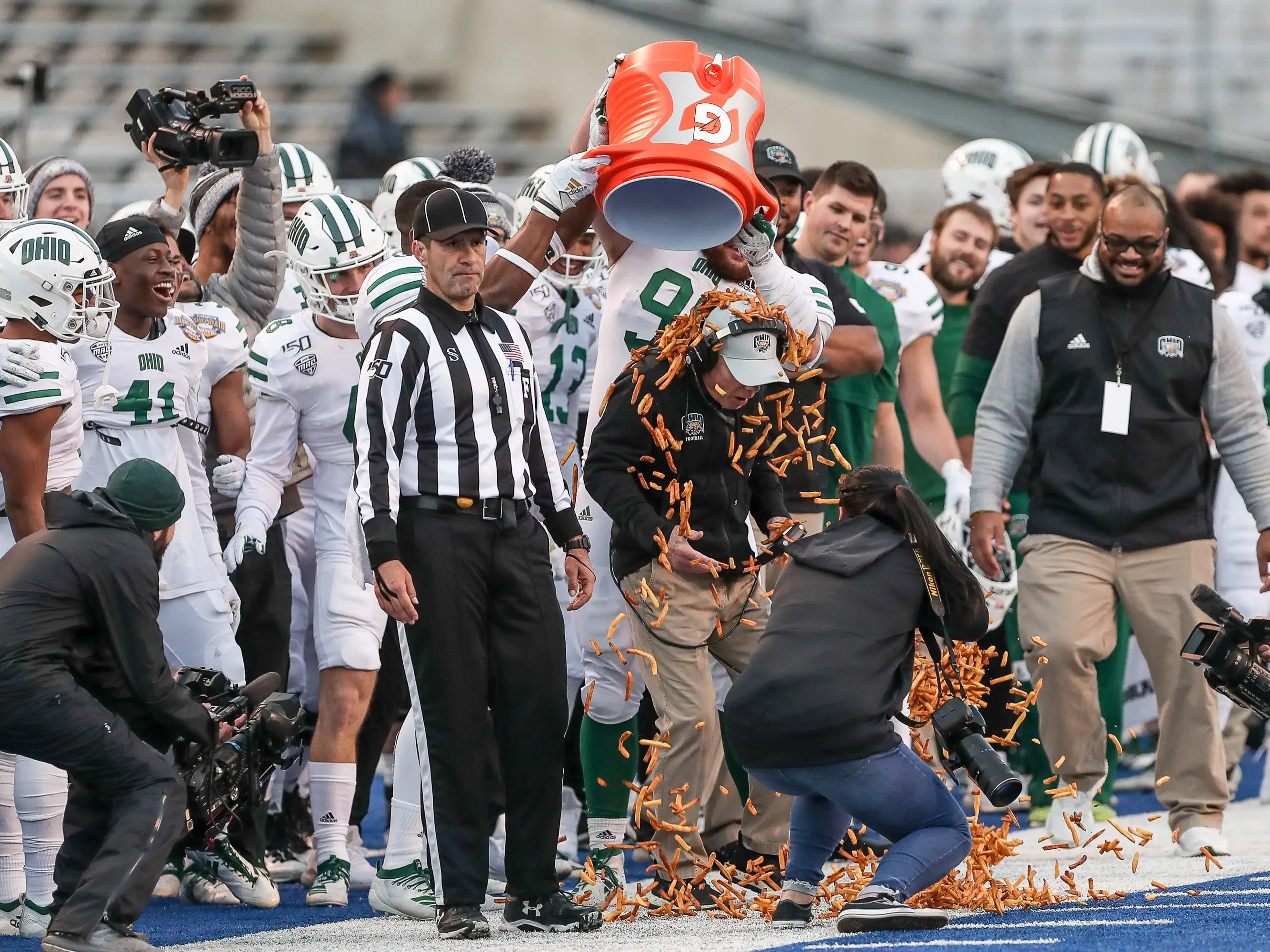 Head Coach Frank Solich of the Ohio Bobcats gets showered with french fries during second half action against the Nevada Wolf Pack at the Famous Idaho Potato Bowl on January 3, 2020 at Albertsons Stadium in Boise, Idaho.