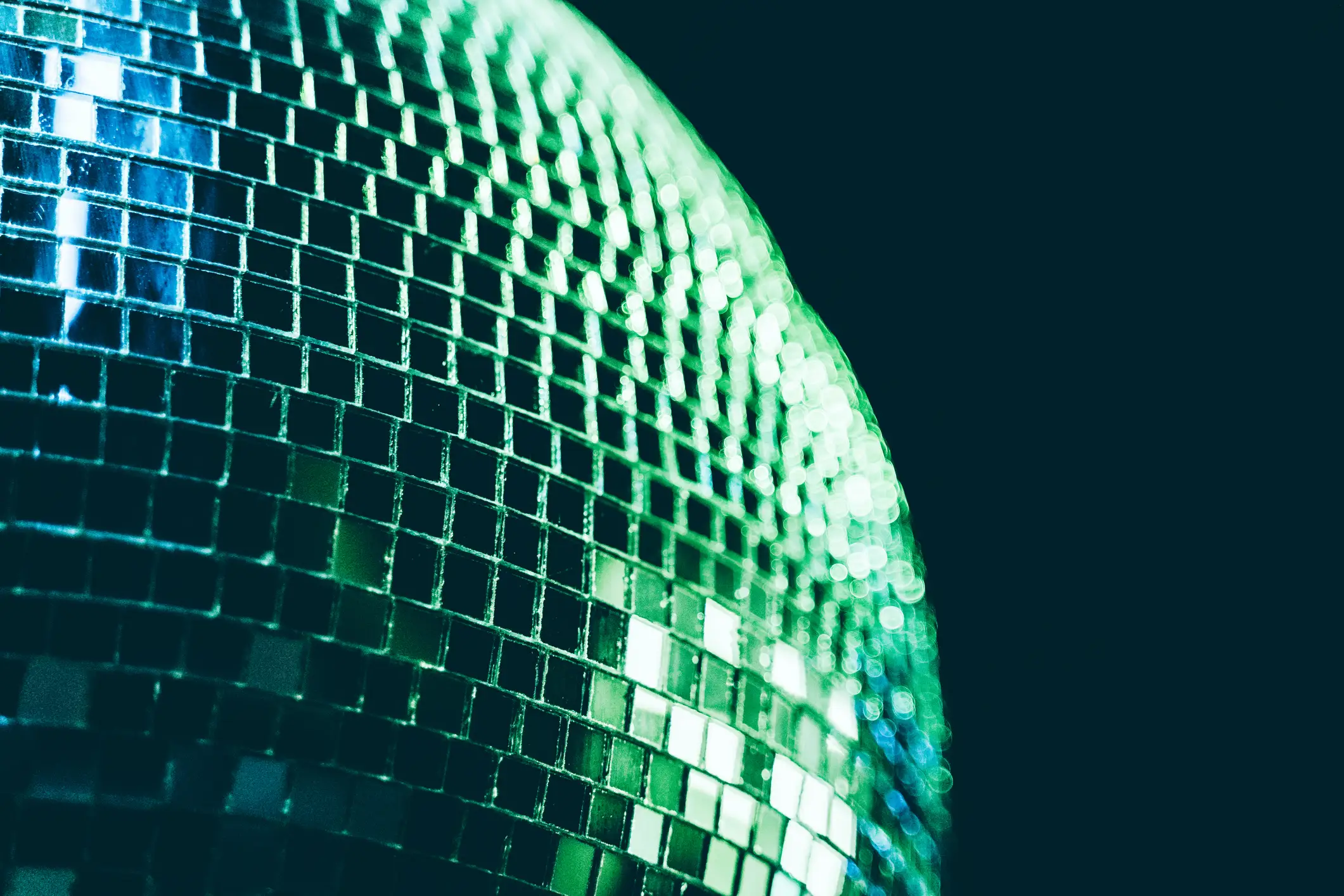 A green disco ball, like the one used on the Spotify app
