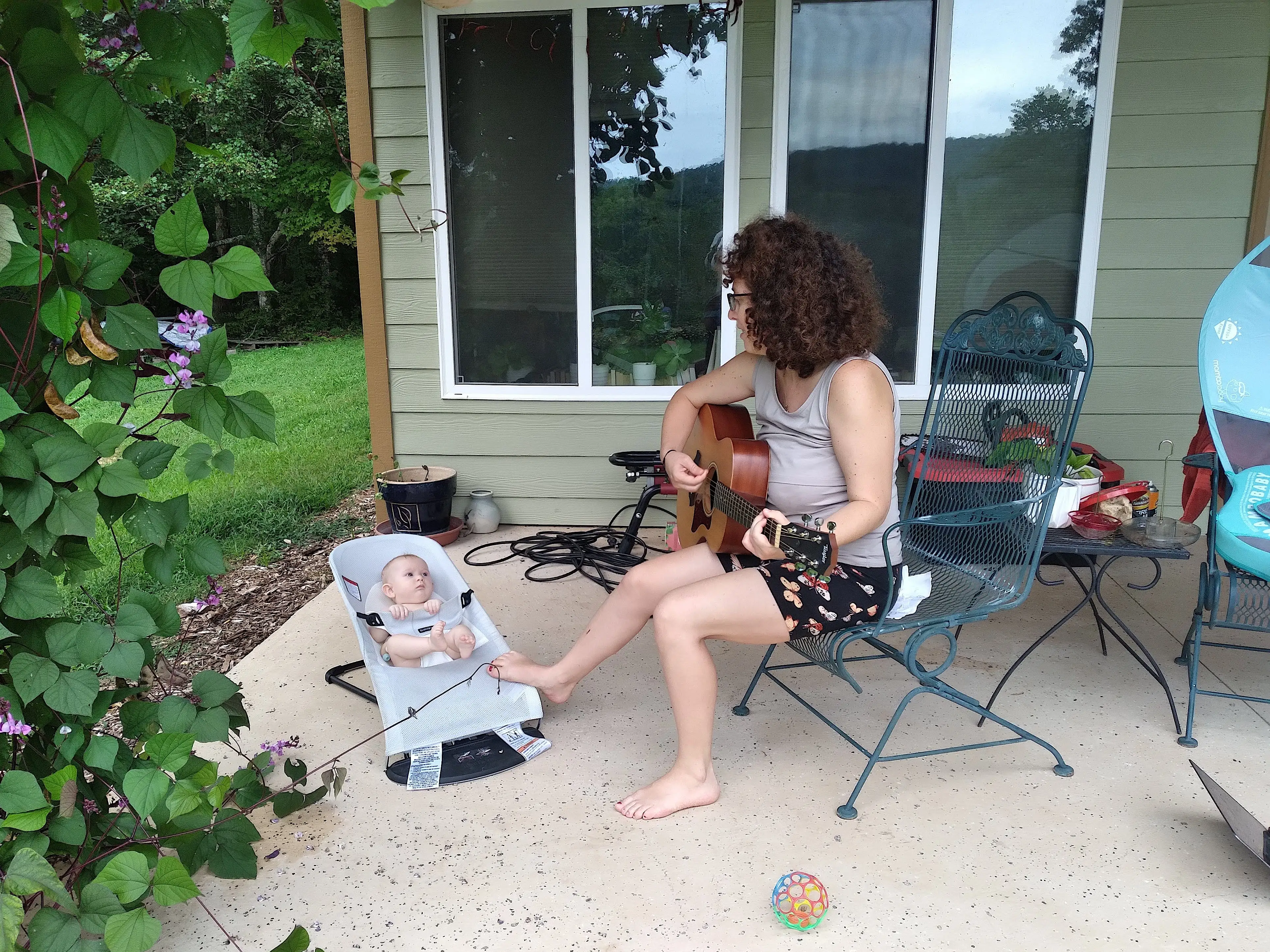 The author playing guitar for her daughter when she was a baby.