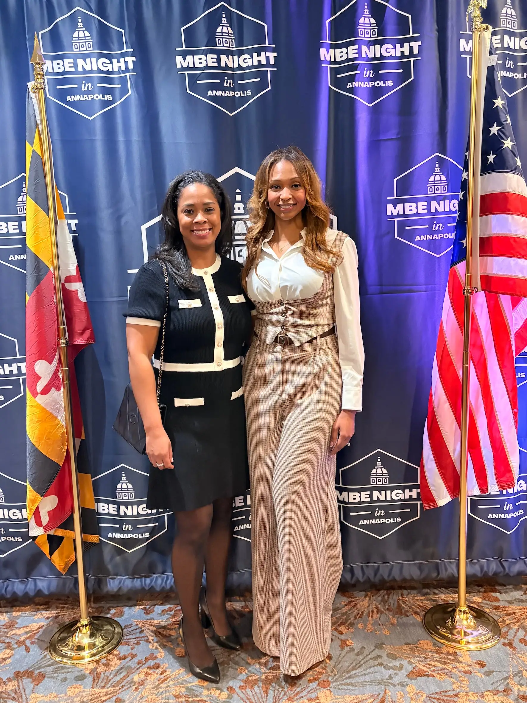 Alexandra Tyson and Felicia Jones Taylor standing in front of a step and repeat.