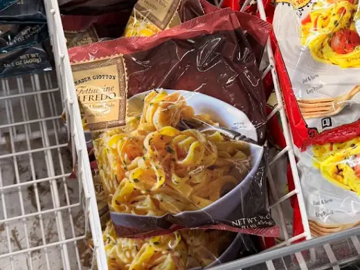 Several bags of Trader Joe's fettucini Alfredo.