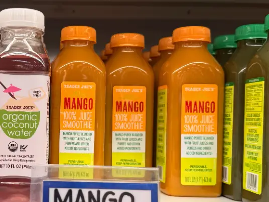 Several bottles of Trader Joe's mango smoothies.