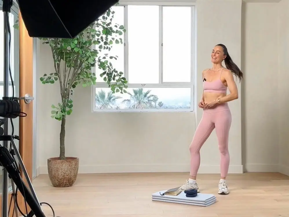 Megan Roup filming a workout video.