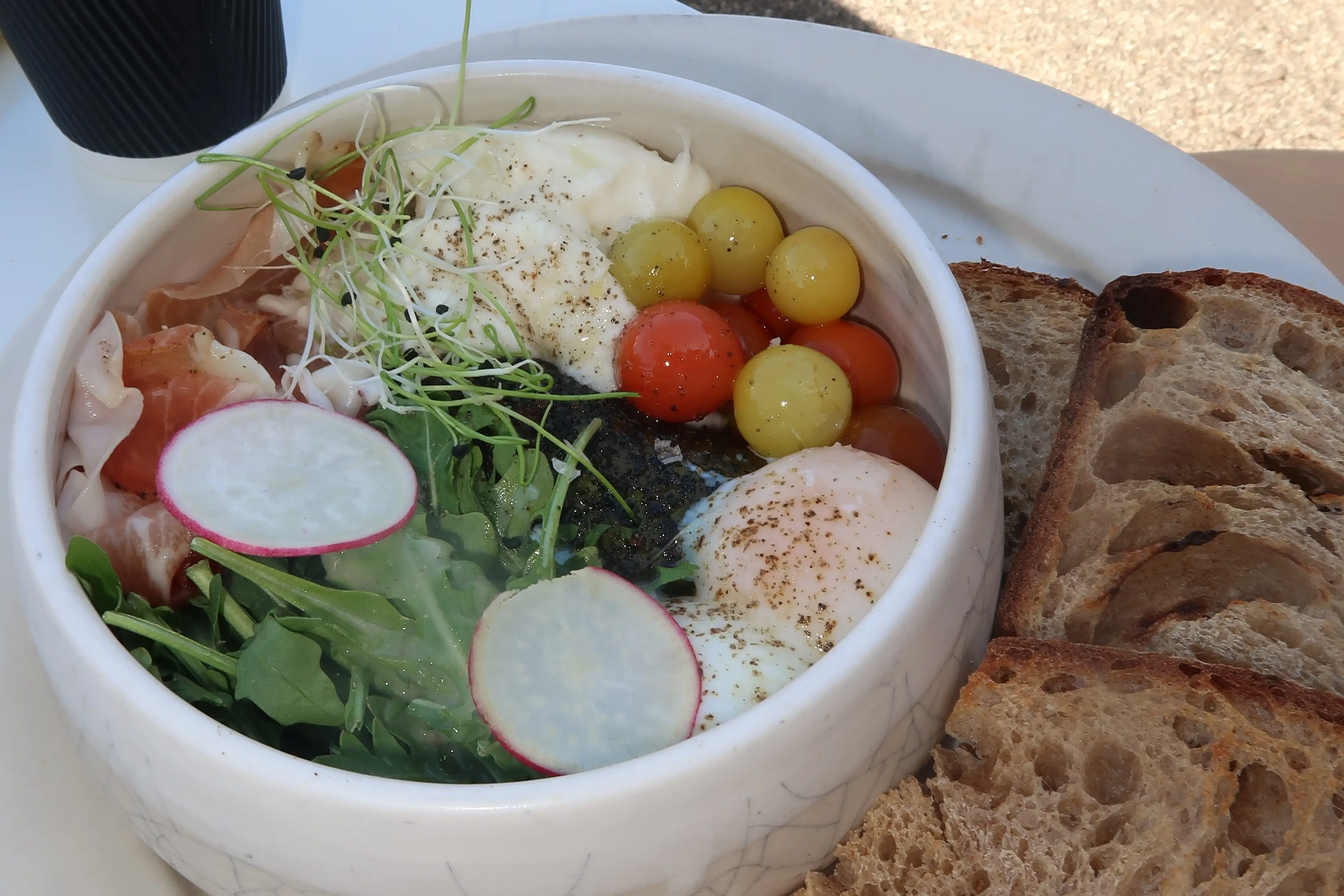 A salad with a side of sourdough toast.