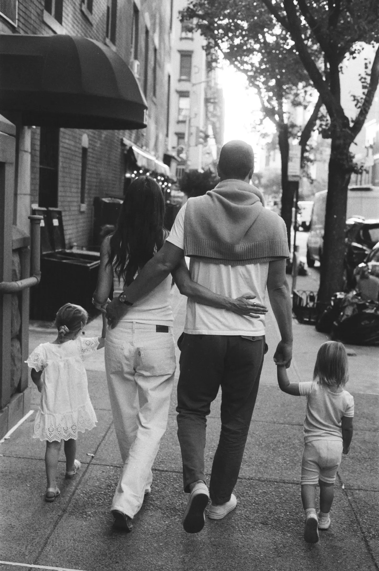 A family walk down the street.
