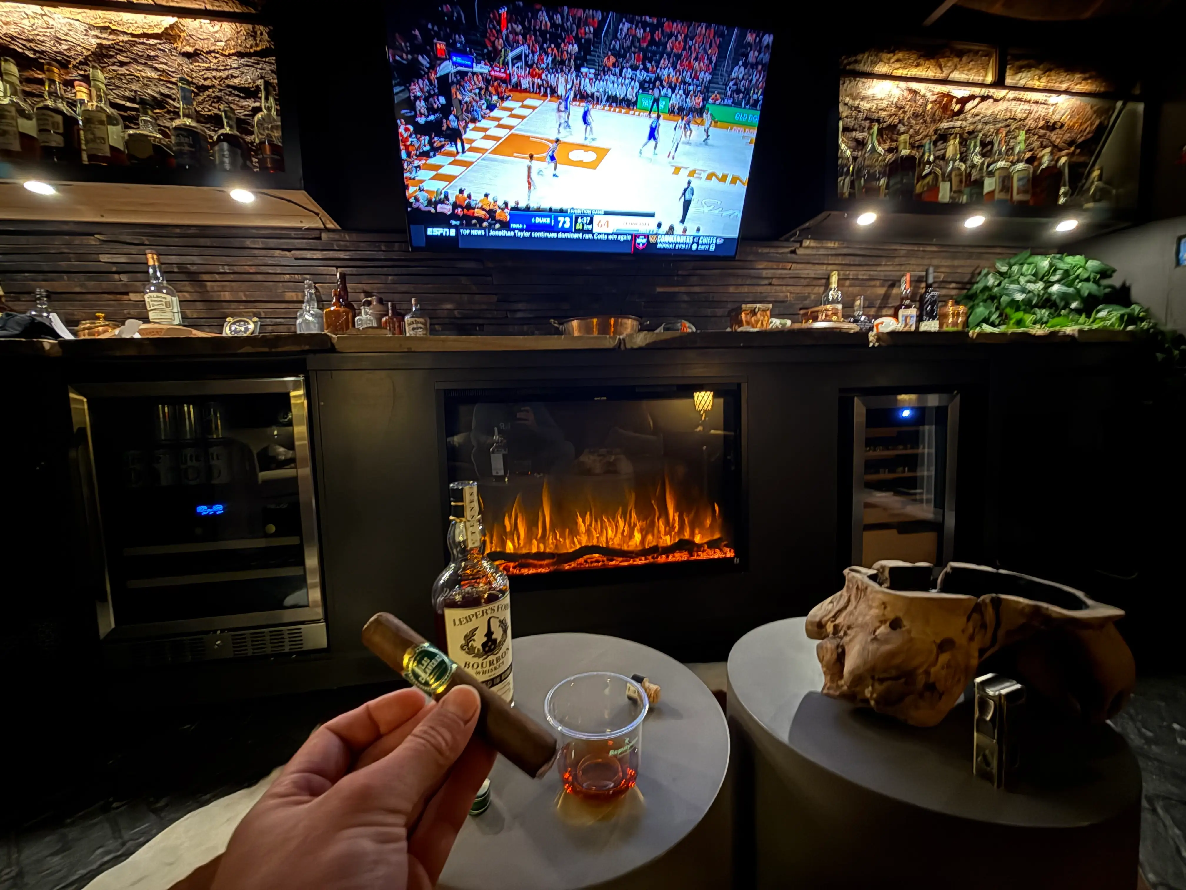 Tyler Graham enjoying a cigar and whiskey inside his man cave.