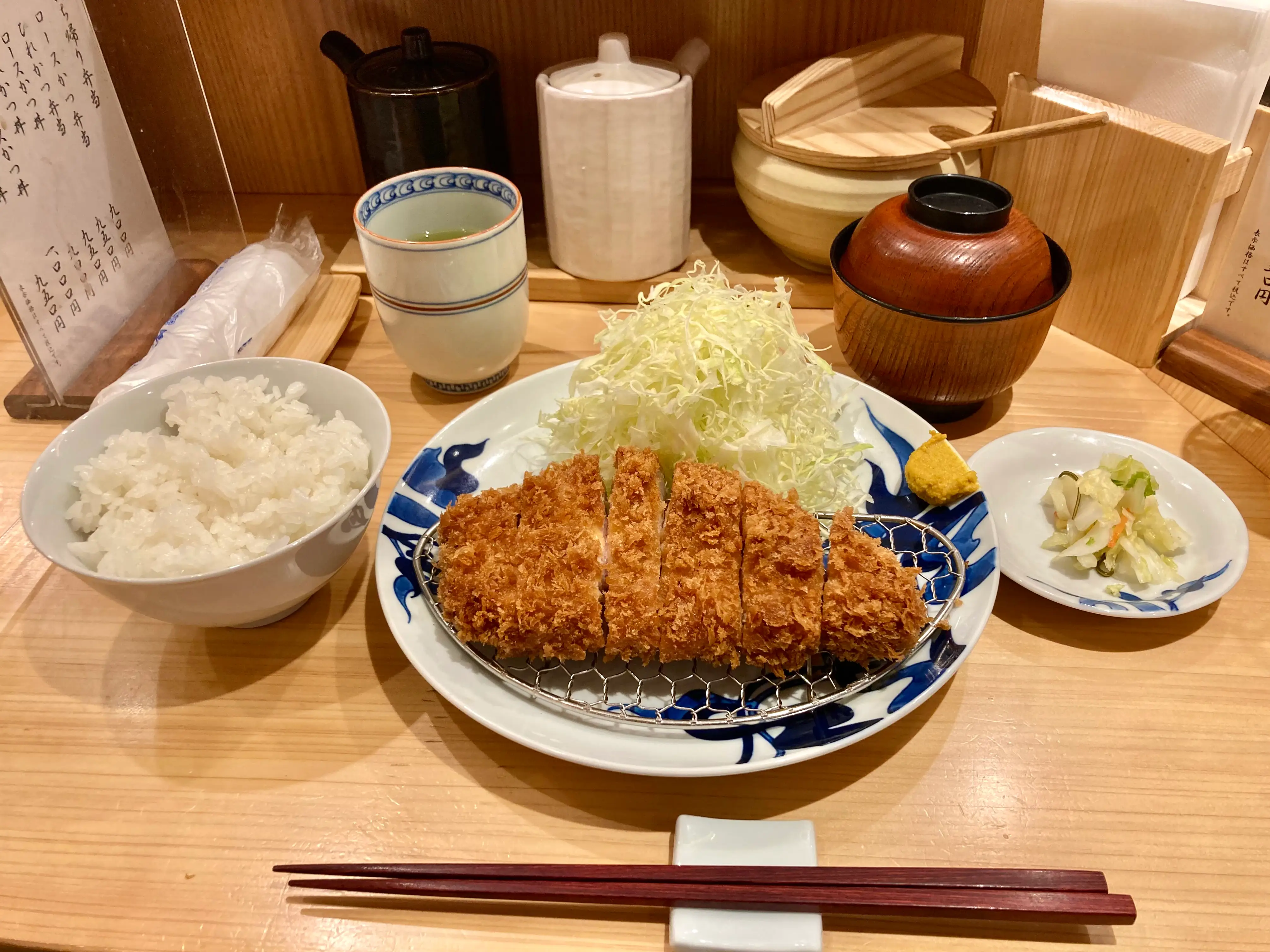 Katsu meal with rice, drink, chopsticks,  in solo dining area